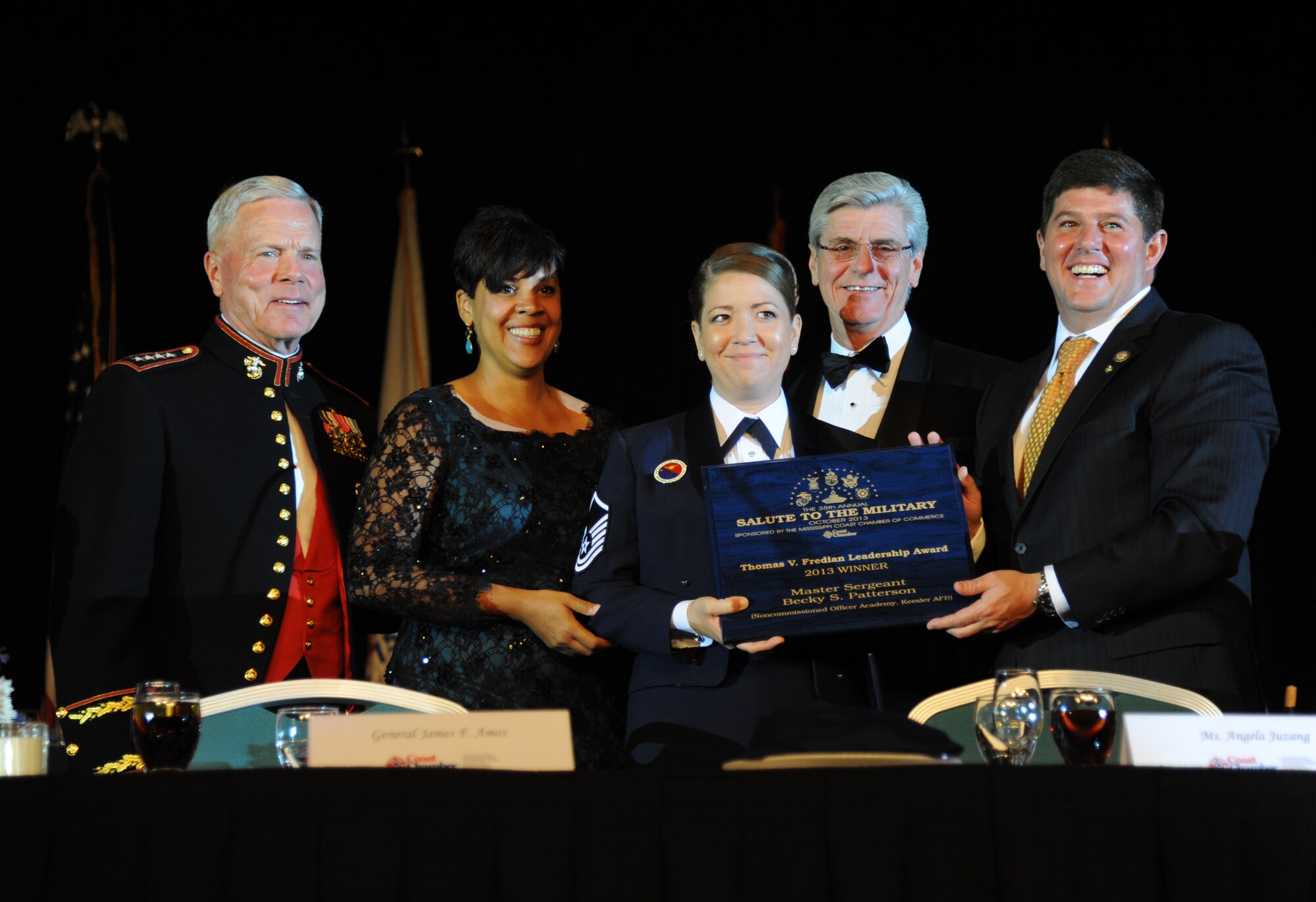 U.S. Air Force Master Sgt. Becky Patterson, Mathies NCO Academy, Keesler Air Force Base, (center), takes a photo with Gen. James Amos, Commandant of the Marine Corps; Angela Juzang, Mississippi Gulf Coast Chamber of Commerce Chair; Mississippi Gov. Phil Bryant and Congressman Steven Palazzo, Mississippi’s Fourth Congressional District, during the 35th Annual Salute to the Military Oct. 22, 2013, at the Mississippi Coast Coliseum in Biloxi, Miss.  Patterson was recognized as the winner of the Thomas V. Fredian Community Leadership Award at the event.  (U.S. Air Force photo by Kemberly Groue)