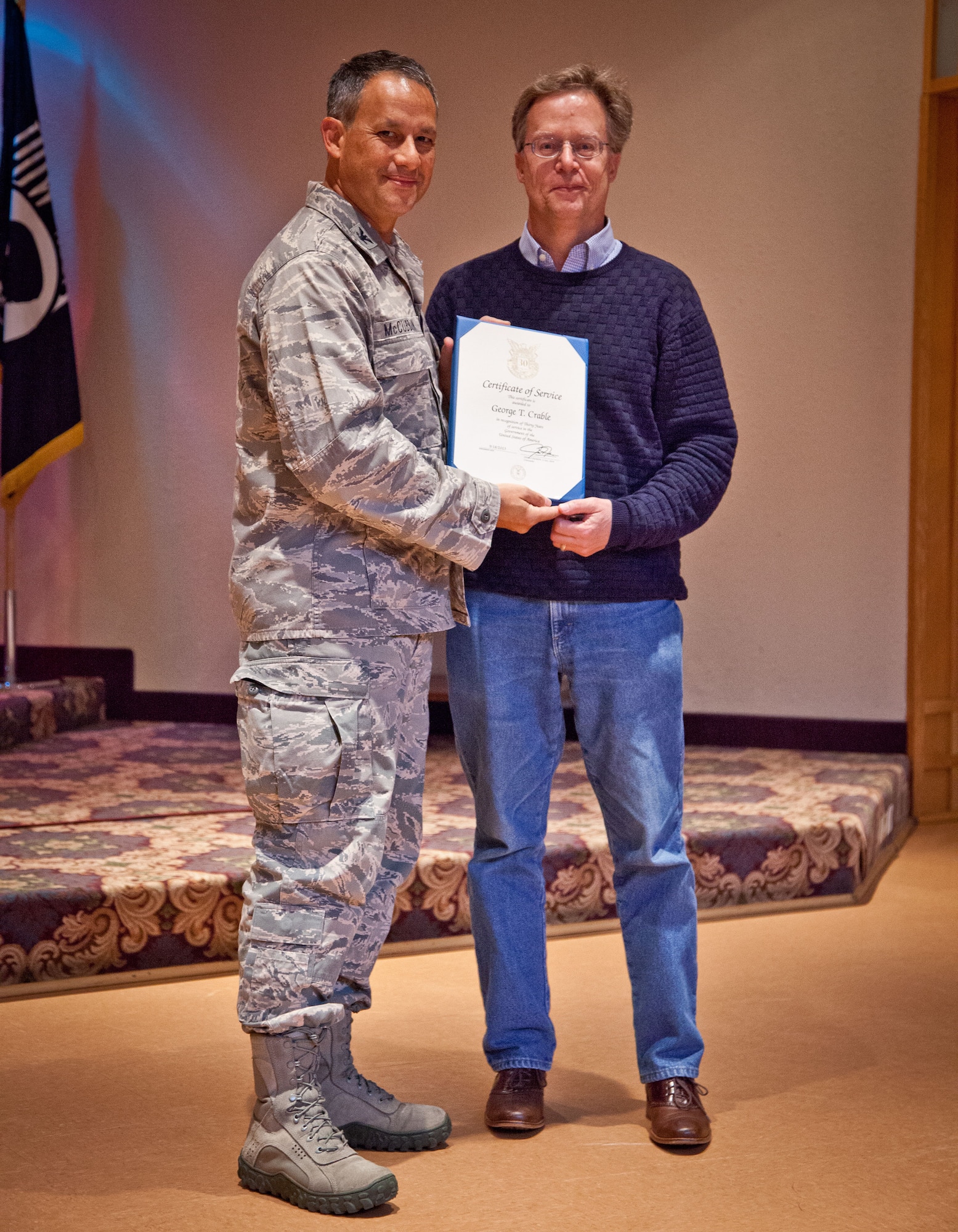Col. Todd McCubbin, 934th Airlift Wing commander, presents George Crable with his Employee Service Award for 30 years of service during the Civilian Commander's Call at the Services Club at Minneapolis-St. Paul Air Reserve Station, Minn.  (U.S. Air Force photo/Shannon McKay)