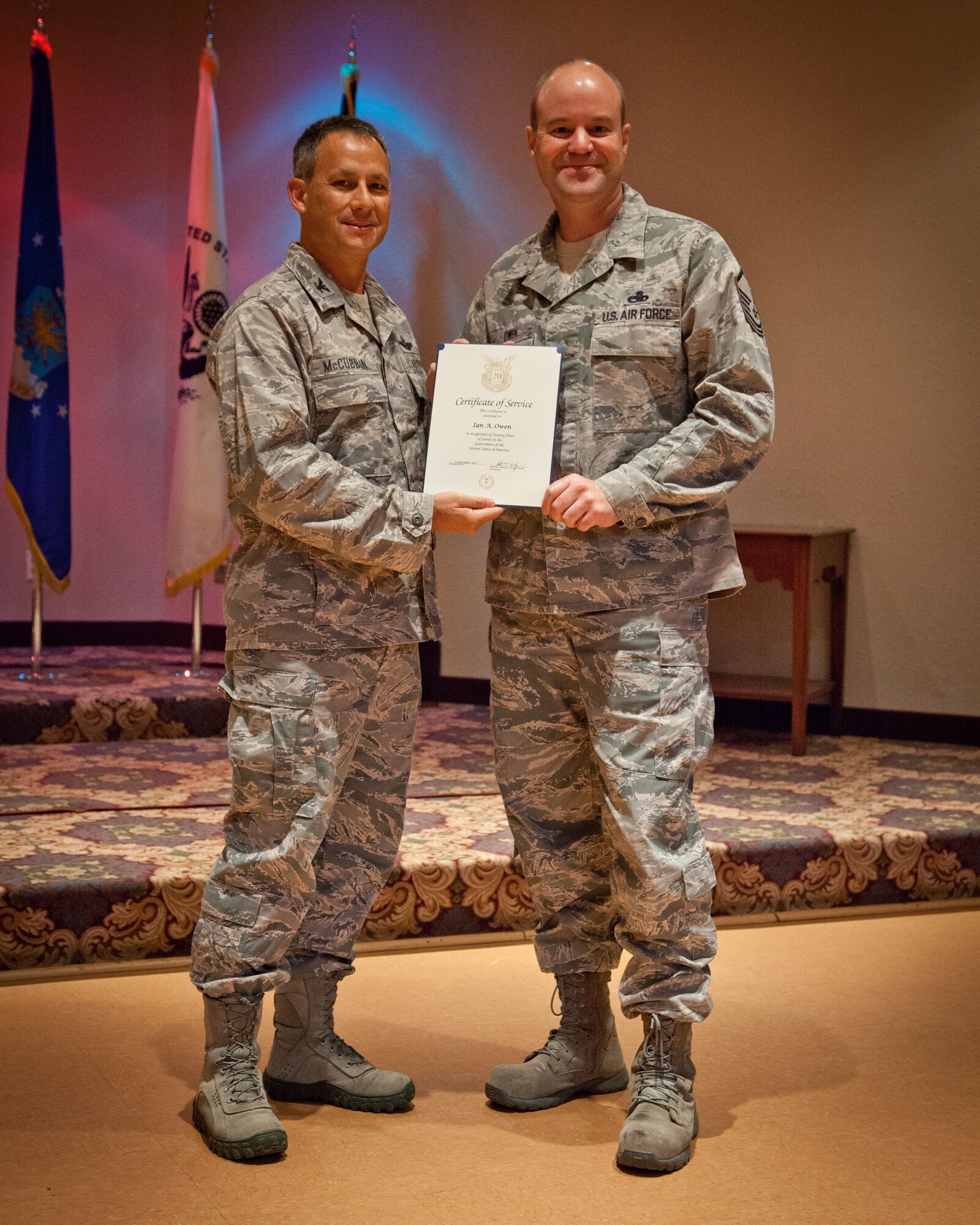 Col. Todd McCubbin, 934th Airlift Wing commander, presents Master Sgt. Ian Owen with his Employee Service Award for 20 years of service during the Civilian Commander's Call at the Services Club at Minneapolis-St. Paul Air Reserve Station, Minn.  (U.S. Air Force photo/Shannon McKay)