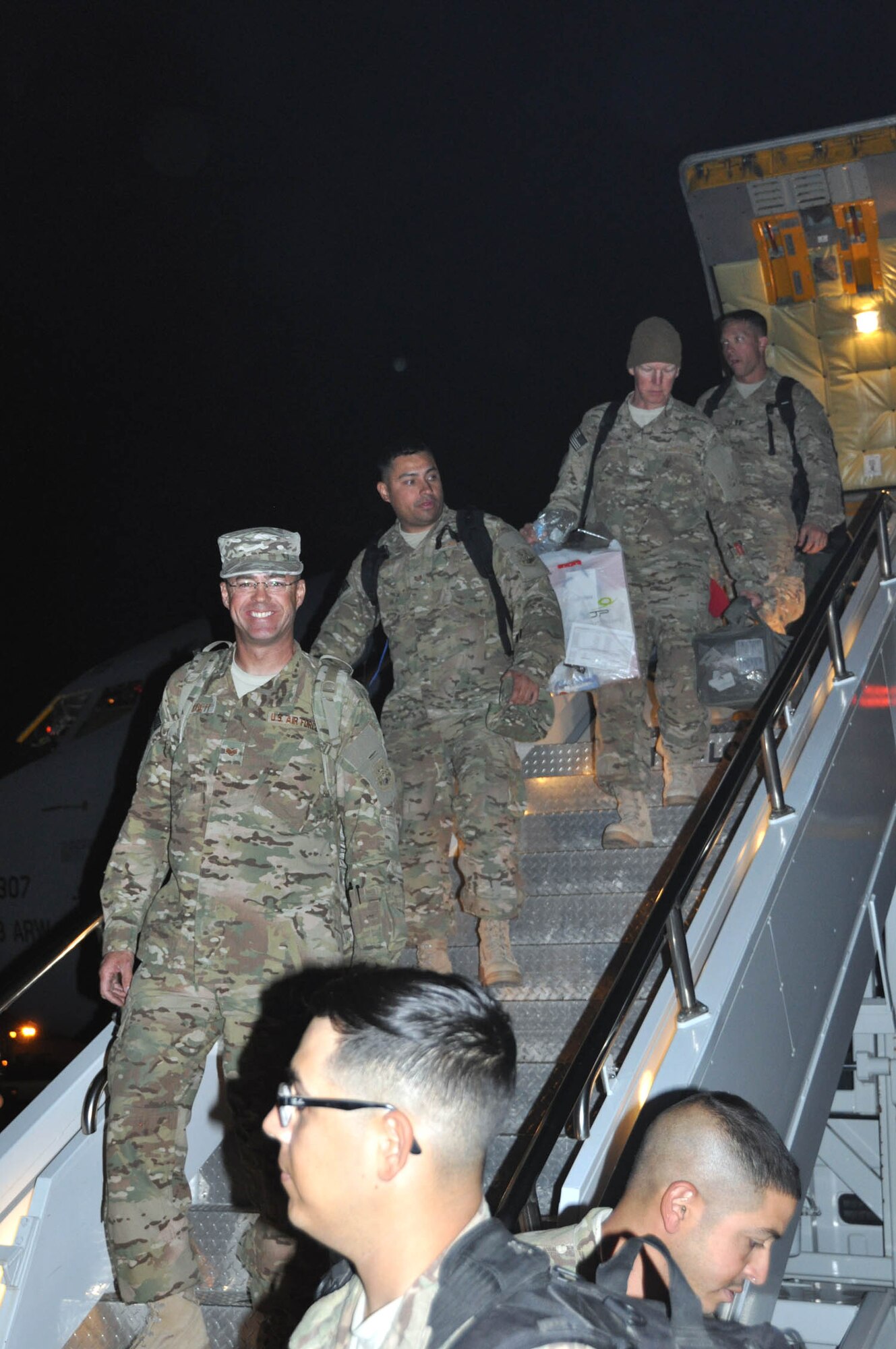 NELLIS AIR FORCE BASE, Nev. -- Personnel from the 555th RED HORSE Squadron deplane the KC-135 aircraft that brought them home to Nellis Air Force Base, Nev., on Oct. 22 from a six-month deployment to Southwest Asia. The squadron deployed more than 30 members to various locations in the region where they repostured and dispositioned assets, and closed down camp sites, among other retrograde efforts. Rapid Engineer Deployable Heavy Operational Repair Squadron Engineers provide a mobile, self-sufficient force responsible for heavy repair and construction in remote environments. (U.S. Air Force photo/Maj. Jessica Martin)