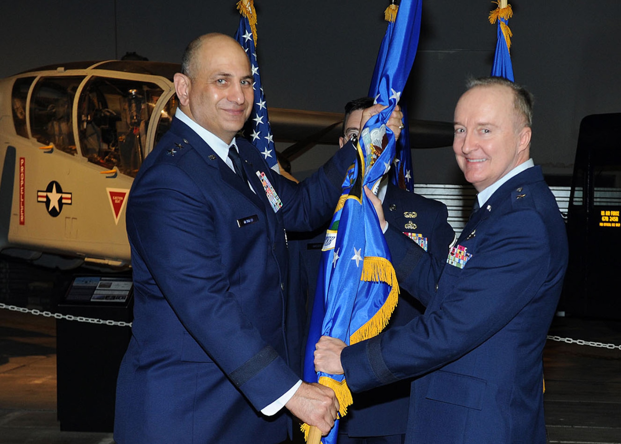 Brig. Gen. Edmund D. Walker, Force Generation Center commander, accepts the unit flag from Maj. Gen. Richard “Beef” Haddad, Air Force Reserve Command vice commander, during a change of command ceremony at the Museum of Aviation here Oct. 16. Walker assumed command of the FGC from Brig. Gen. Stephen “Fritz” Linsenmeyer. (U.S. Air Force photo/Tommie Horton) 