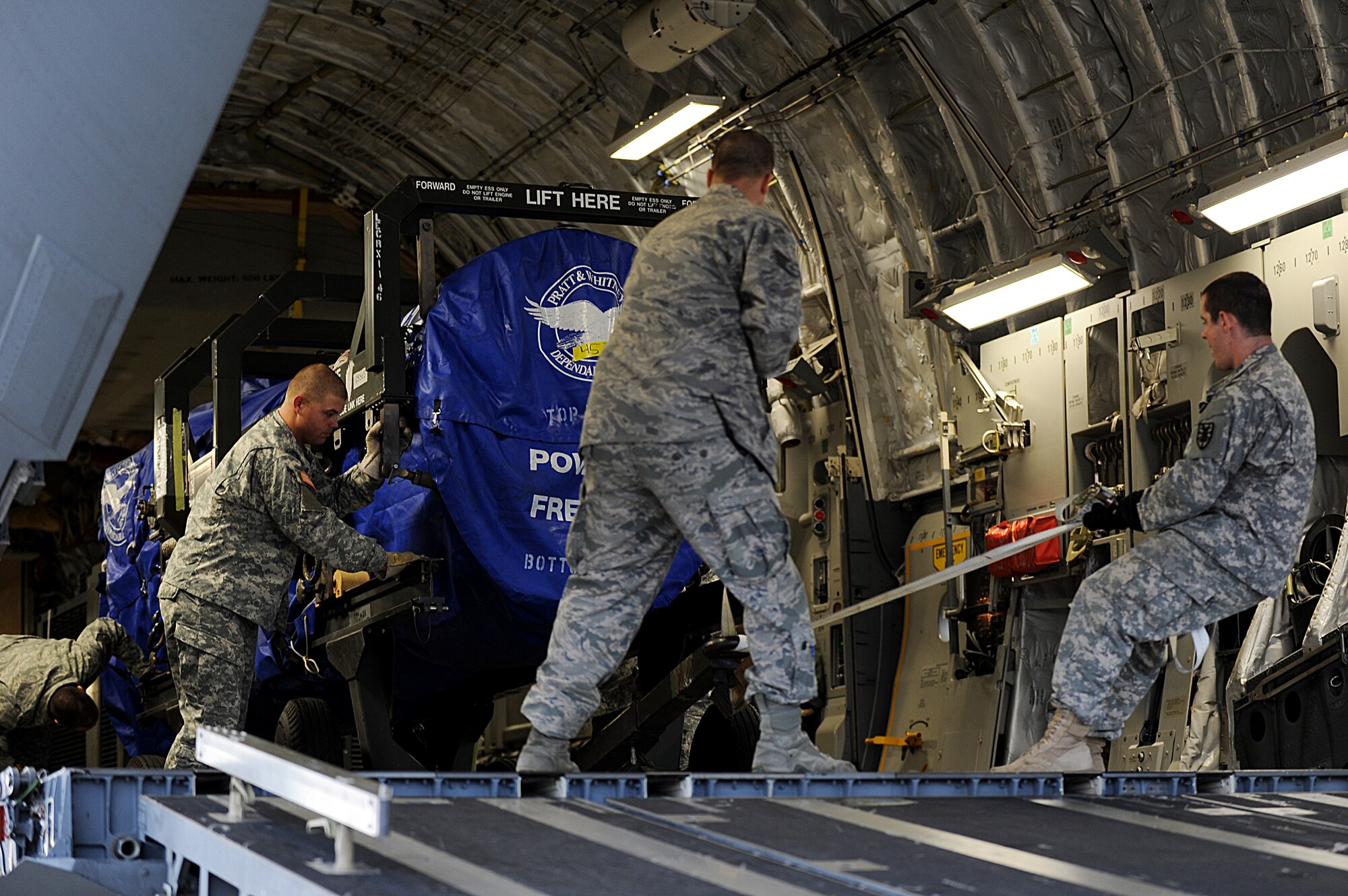 U.S. Army Soldiers from the 622nd Movement Control Detachment from Fort Eustis, Va., and U.S. Air Force Airmen from the 633rd Logistics Readiness Squadron work together to unload cargo from a C-17 Globemaster III at Langley Air Force Base, Va., Oct. 23, 2013. The joint operation provided the Airmen and Soldiers an opportunity to hone their skills together. (U.S. Air Force photo by Staff Sgt. Jarad A. Denton/Released)