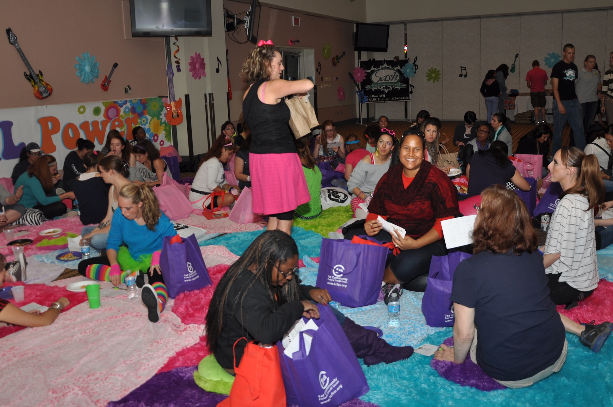 GOODFELLOW AIR FORCE BASE, Texas – Women from all over Goodfellow participate in SARC-O, a version of Bingo, created by Donna Casey, Sexual Assault Response Coordinator, during Girls Night Out, Oct. 19 at the Event Center. Questions about actors, songs, and movies were asked during SARC-O to attribute to the 80’s theme. (U.S. Air Force photo/ Airman 1st Class Breonna Veal) 