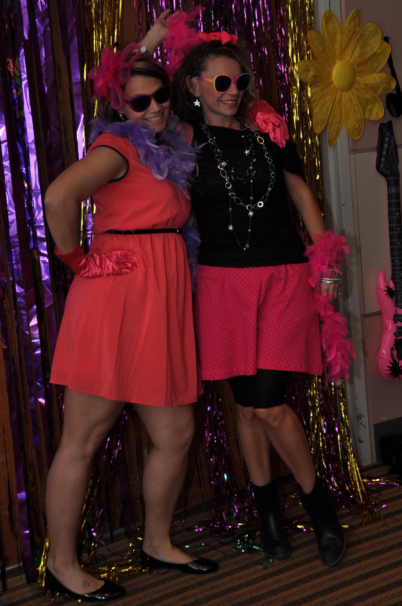 GOODFELLOW AIR FORCE BASE, Texas – Donna Casey, Sexual Assault Response Coordinator, and her sister, Mary Payton, pose for a photo at the photo booth during Girls Night Out, Oct. 19 at the Event Center. A fashion show and a photo booth were a part of this year’s 80’s theme. (U.S. Air Force photo/ Airman 1st Class Breonna Veal)  