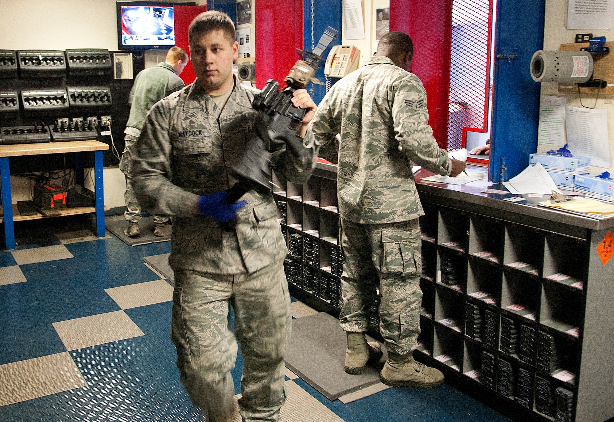 131021-F-JW079-122
Senior Airman Troy Maycock, 90th Security Support Squadron, carries a recently turned-in M4 rifle back to the armory’s shelves as Senior Airman Randall Mitchell, 90th SSPTS, waits on a customer during their shift Oct. 21. The 90th SSPTS armory supports the 90th Security Forces Group’s squadrons by issuing and receiving hundreds of weapon’s daily. (U.S. Air Force photo by R.J. Oriez)
