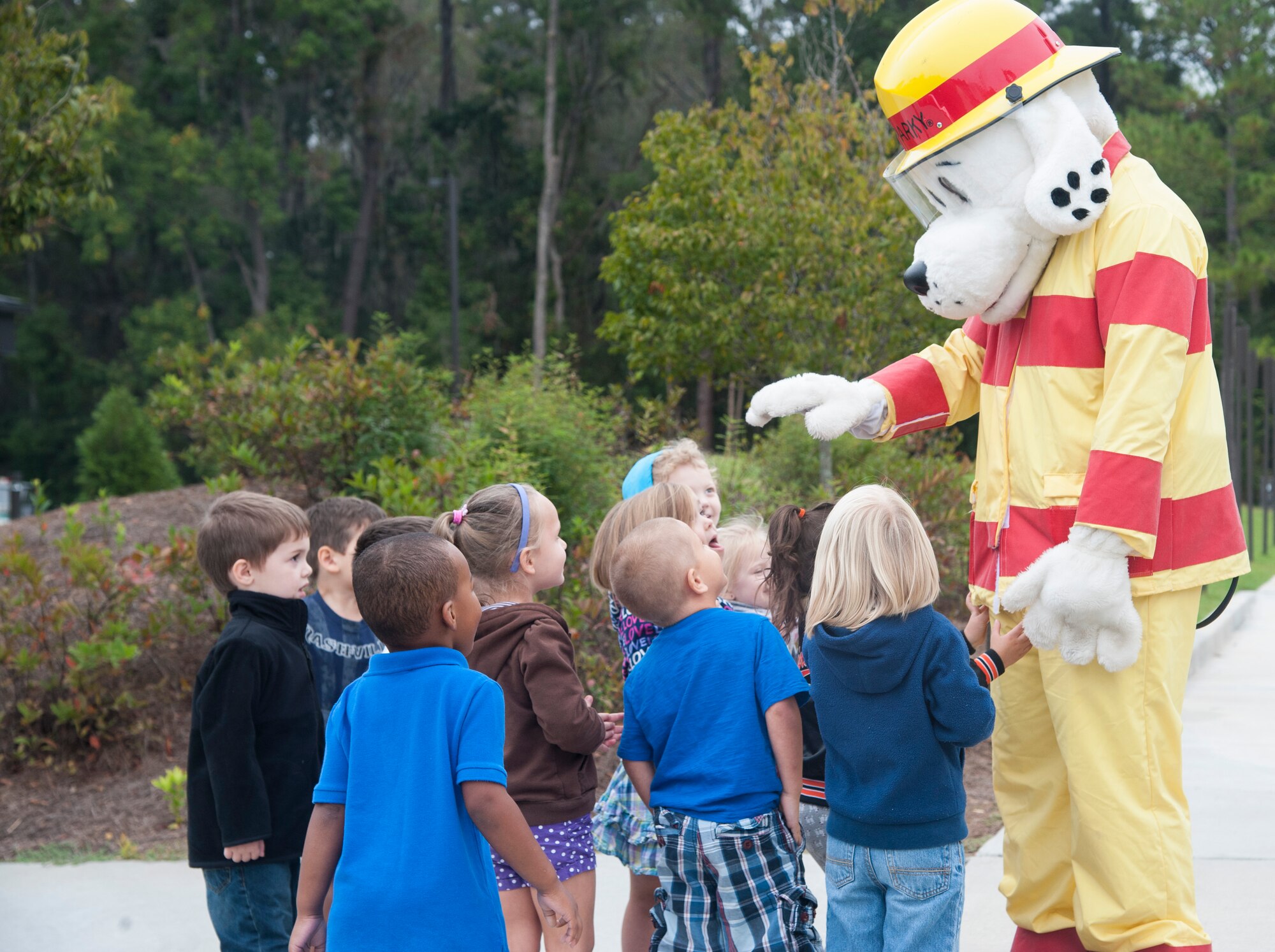Sparky the Fire Dog greets children at the Child Development Center at Moody Air Force Base, Ga., Oct. 9, 2013. Sparky is the mascot for the National Fire Protection Association and Fire Prevention Week. (U.S. Air Force photo by Airman Dillian Bamman/Released)