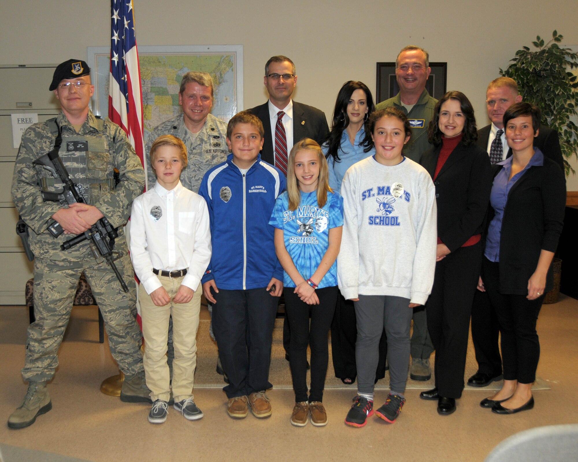 Children from St. Mary's school  XXXX pose for a group photo with (left to right) Staff Sgt. Patrick Parkot, 914th Security Forces Squadron team member, LtCol. James Lawson, Commander 914th Security Forces Squadron, Mr. Brian Boetig, Special Agent in Charge, FBI Buffalo Division, Ms. XXXX  Teacher St. Mary's School, Col. Walter Gordon, Commander, 914th Airlift Wing, Special Agent Maureen Dempsey, Special Agent Darin Schultz, and Ms. Megan Calero, Family and Readiness Director, 914th Airlift Wing on October 23, 2013 at the Niagara Falls Air Reserve Station, NY. The children raised awareness of the plight of homeless Veterans in Western New York and also were recognized by the FBI for their genuine efforts in improving their community. (U.S. Air Force photo by Mr. Peter Borys)