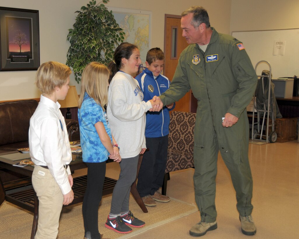 Col. Walter Gordon, 914th Airlift Wing Commander hands out the commander's coins to students of St. Mary’s school on October 23, 2013 at the Niagara Falls Air Reserve Station, NY. The students were on hand and recognized for their work on a school project to raise awareness of homeless vets. Agents from the Buffalo FBI Division were also on hand to present them with items encouraging patriotism and recognizing tomorrow's leaders for their genuine efforts in improving the community. (U.S. Air Force photo by Peter Borys)