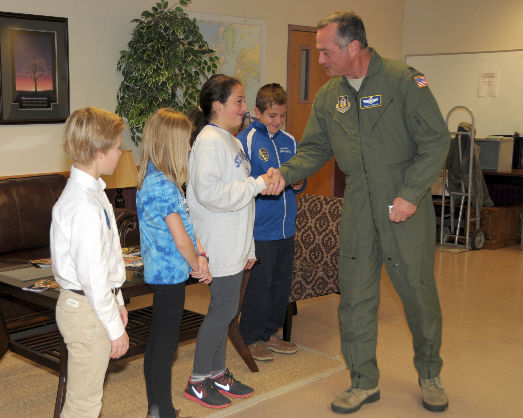 Col. Walter Gordon, 914th Airlift Wing Commander hands out the commander's coins to students of St. Mary’s school on October 23, 2013 at the Niagara Falls Air Reserve Station, NY. The students were on hand and recognized for their work on a school project to raise awareness of homeless vets. Agents from the Buffalo FBI Division were also on hand to present them with items encouraging patriotism and recognizing tomorrow's leaders for their genuine efforts in improving the community. (U.S. Air Force photo by Peter Borys)