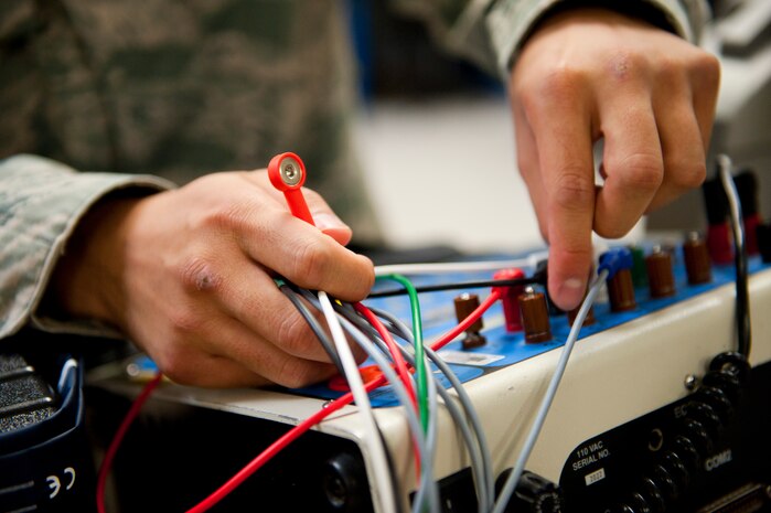 Airman 1st Class Eugene Mac, 99th Medical Support Squadron biomedical equipment technician, prepares an Automatic External Defibrillator for testing at the Mike O’Callaghan Federal Medical Center Oct. 17, 2013, at Nellis Air Force Base, Nev. The MDSS controls more than 5,300 pieces of equipment worth more than $50 million. (U.S. Air Force photo by Airman 1st Class Thomas Spangler)        