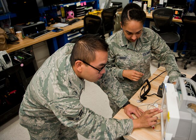 Airman 1st Class Eugene Mac and Airman 1st Class Kassandra Jarvis, 99th Medical Support Squadron biomedical equipment technicians, test a patient monitor at the Mike O’Callaghan Federal Medical Center Oct. 17, 2013, at Nellis Air Force Base, Nev. Approximately six hundred pieces of medical equipment undergo scheduled maintenance and testing every month. (U.S. Air Force photo by Airman 1st Class Thomas Spangler)