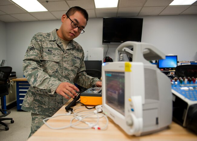 Airman 1st Class Eugene Mac, 99th Medical Support Squadron biomedical equipment technician, prepares a patient monitor for testing at the Mike O’Callaghan Federal Medical Center Oct. 17, 2013, at Nellis Air Force Base, Nev. Patient monitors continuously monitor a patient’s vital signs. (U.S. Air Force photo by Airman 1st Class Thomas Spangler)