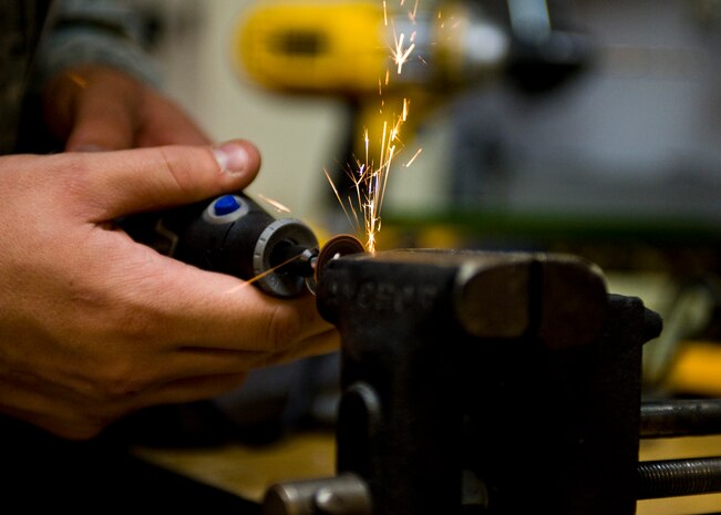 Staff Sgt. Michael Muschong, 99th Medical Support Squadron biomedical equipment supervisor, fabricates a bolt to repair a patient mobilization system at the Mike O’Callaghan Federal Medical Center Oct. 17, 2013, at Nellis Air Force Base, Nev. Biomedical equipment Airmen are responsible for assembling, installing, and inspecting new equipment. Airmen also ensure the equipment is working properly and complies with medical and technical standards, specifications, contracts and regulatory guidance. (U.S. Air Force photo by Airman 1st Class Jason Couillard)