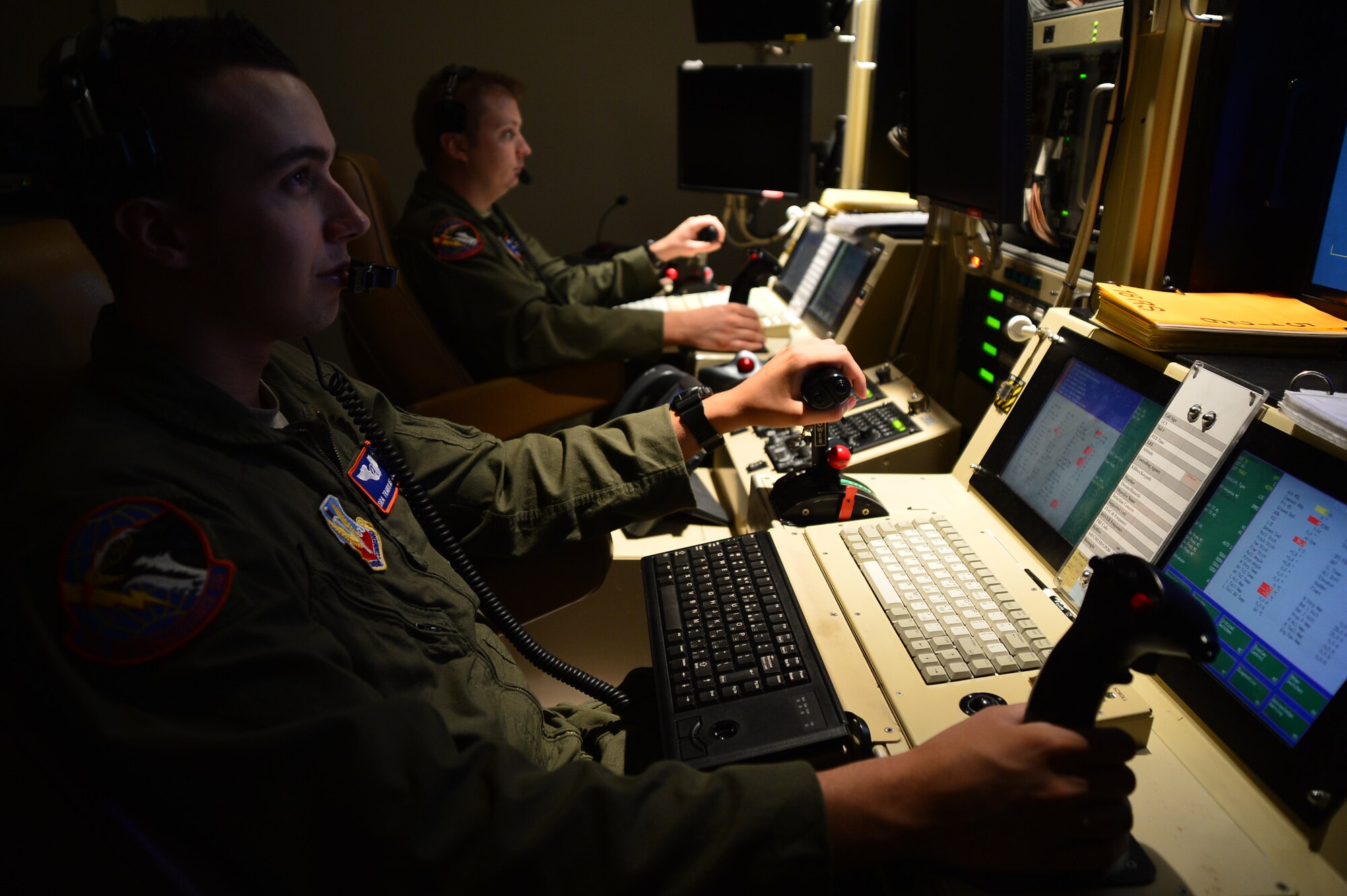 Senior Airman Travis, 432nd Wing/432nd Air Expeditionary Wing Remotely Piloted Aircraft sensor operator, and Capt. Ben, 432nd Wing/432nd AEW RPA pilot, fly an MQ-1 Predator during the wings 2 million flying hour milestone Oct. 22, 2013. The wing flew its first 1 million hours in April 2011. The wing’s 2 million hour mark was achieved 32 months later, culminating in more than 215,000 total missions completed and nearly 94 percent of all missions flown in support of major combat operations due in large part to total force integration efforts and an expansion of combat air patrols. (U.S. Air Force photo by Staff Sgt. N.B./released)