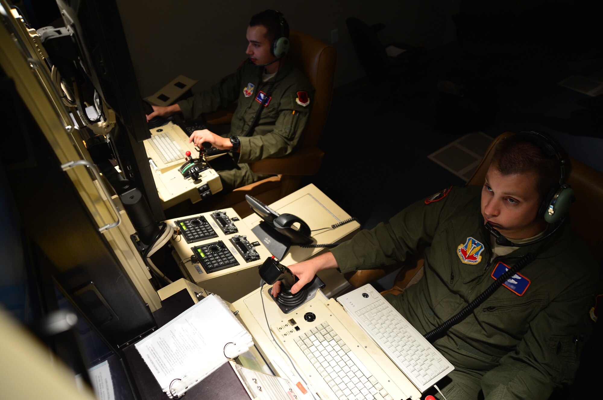 Capt. Ben, (right) 432nd Wing/432nd Air Expeditionary Wing Remotely Piloted Aircraft pilot, and Senior Airman Travis, 432nd Wing/432nd AEW RPA sensor operator, fly an MQ-1 Predator during the wing’s 2 million flying hour milestone Oct. 22, 2013. The wing flew its first 1 million hours in April 2011. The wing’s 2 million hour mark was achieved 32 months later, culminating in more than 215,000 total missions completed and nearly 94 percent of all missions flown in support of major combat operations due in large part to total force integration efforts and an expansion of combat air patrols. (U.S. Air Force photo by Staff Sgt. N.B./released)