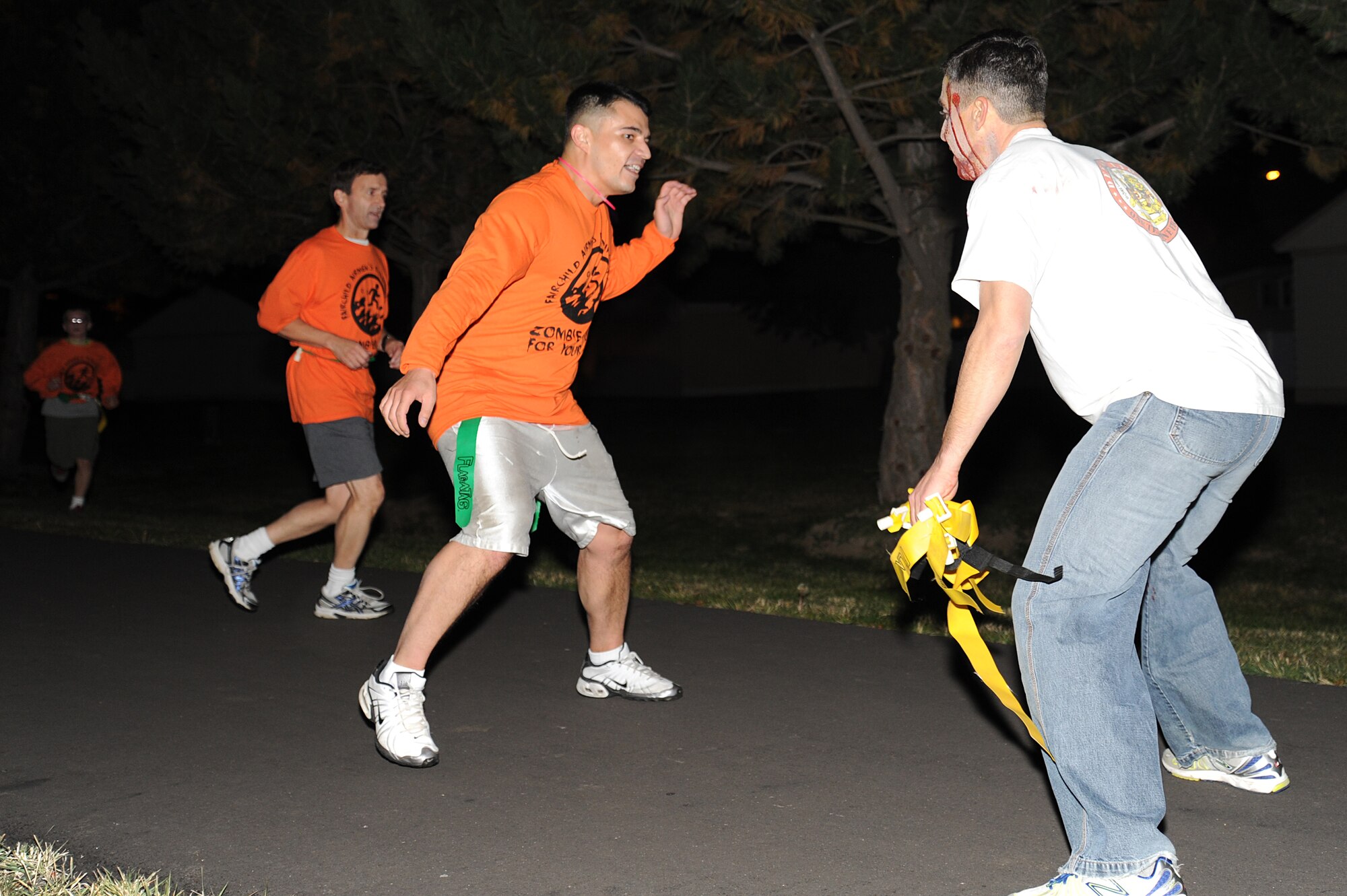 A zombie blocks runners during the Zombie Run at Fairchild Air Force Base, Wash., Oct. 23, 2013. Runners had to avoid zombies from taking their lives in order to win the run. (U.S. Air Force photo by Airman 1st Class Janelle Patiño/Released)