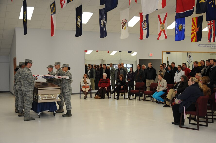 Members of the Grand Forks Chamber of Commerce Annual Leadership Seminar watch a ceremonial demonstration by the Grand Forks Air Force Base Honor Guard Oct. 22, 2013, on Grand Forks AFB, N.D. The group of more than 30 local citizens and businesspeople toured the installation to learn about its mission and personnel. (U.S. Air Force photo/Staff Sgt. David Dobrydney)