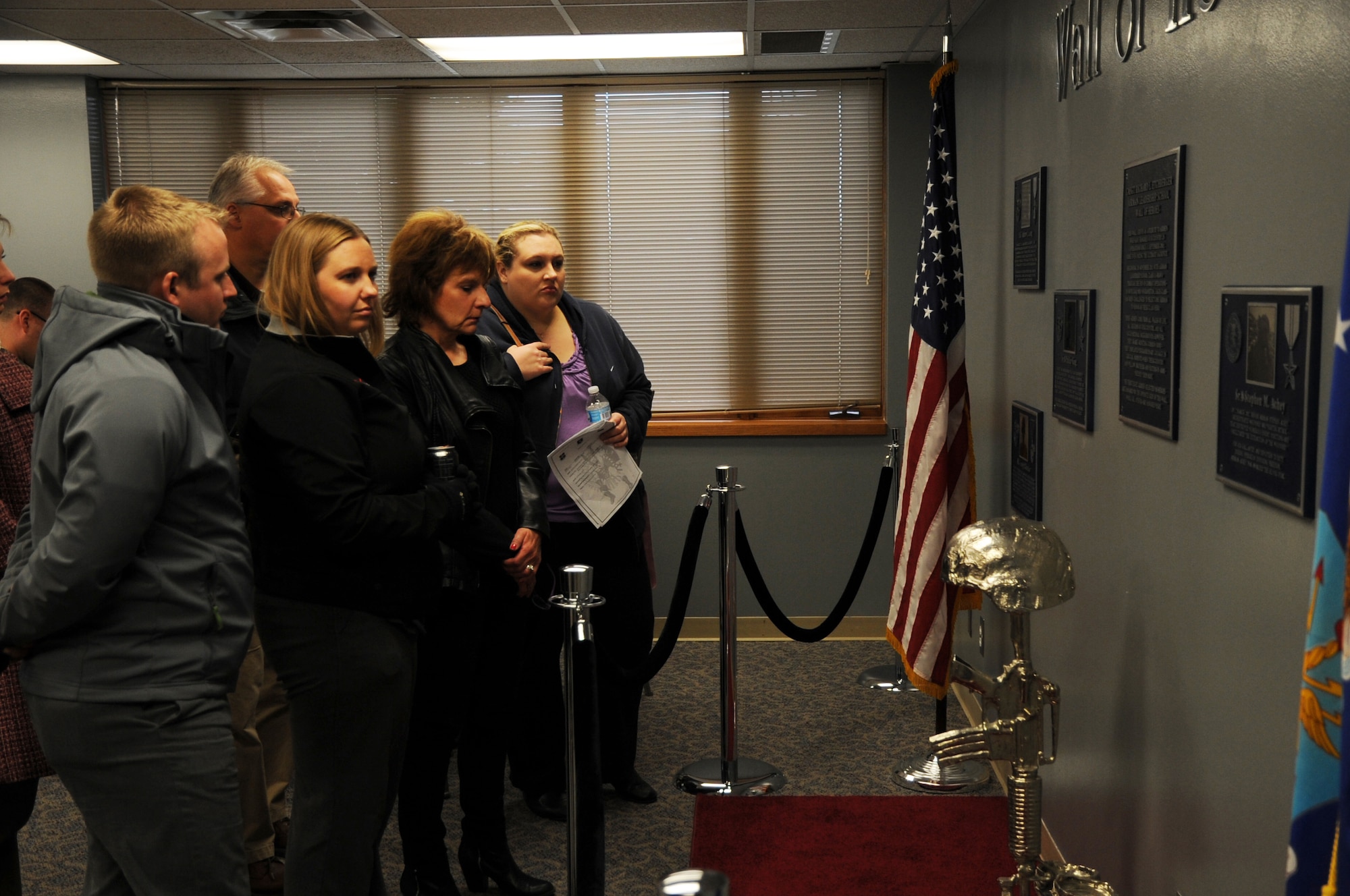 Members of the Grand Forks Chamber of Commerce Annual Leadership Seminar admire the Wall of Heroes at the Chief Master Sgt. Richard L. Etchberger Airman Leadership School on Grand Forks Air Force Base, N.D., Oct. 22, 2013. The group of more than 30 local citizens and businesspeople toured the installation to learn about its mission and personnel. (U.S. Air Force photo/Staff Sgt. David Dobrydney)