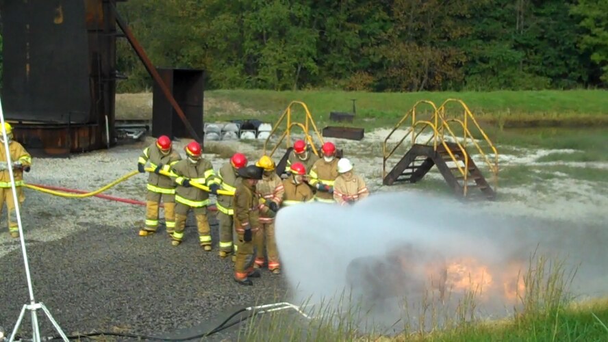 Youngstown Air Reserve Station firefighters train on the hose system of a high pressure rapid intervention vehicle at a Pennsylvania refinery, Sept. 10, 2013. The vehicle, which is the newest in the YARS firefighting fleet, is designed for rapid response offering agility and speed compared to larger vehicles. The vehicle sprays a lower volume at high pressures for fire control and suppression. U.S. Air Force photo by TSgt. Dennis Kilker. 