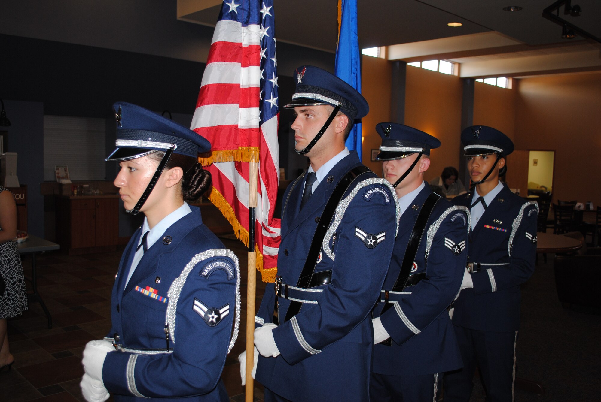With the American flag by his side, Airman 1st Class Joshua Weaver awaits for the signal to lead an honor guard detail down the aisle and present the colors during an Air Force retirement ceremony Aug. 27, 2013, at the Community Activity Center at Grand Forks Air Force Base, N.D. The 23-year-old Airman from Selma, Ind., is the base’s Warrior of the Week for the third week of October 2013. (U.S. Air Force photo/Staff Sgt. Luis Loza Gutierrez) 
