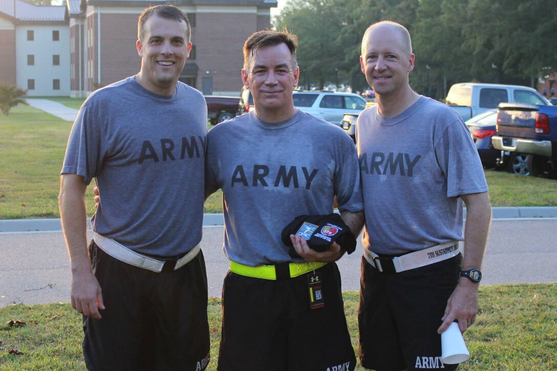 U.S. Army Lt. Col. Noah Cloud, 7th Sustainment Brigade Special Troops Battalion commander, left, Col. William Galbraith, 733rd Mission Support Group commander, center, and Col. Randal Nelson, 7th Sustainment Brigade commander, pose for a photo after a formation run at Fort Eustis, Va., Oct. 4, 2013. The battalion's weekly runs are held to build camaraderie and keep in standards with the fitness program. (U.S. Army photo by 2nd Lt. Hyedi Branch/Released) 