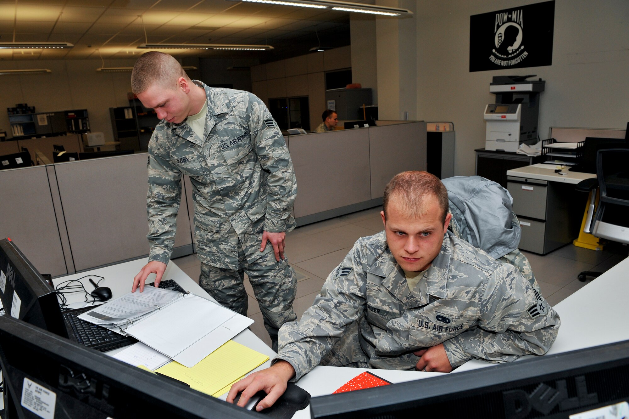 Members of the 460th Space Communications Squadron discuss operations Oct. 22, 2013, during the Panther Challenge at the communications focal point on Buckley Air Force Base, Colo.  The 460th Space Wing hosted the first-ever Panther Challenge, a competition testing operational performance and crew knowledge, throughout October. (U.S. Air Force photo by Senior Airman Phillip Houk/Released)
