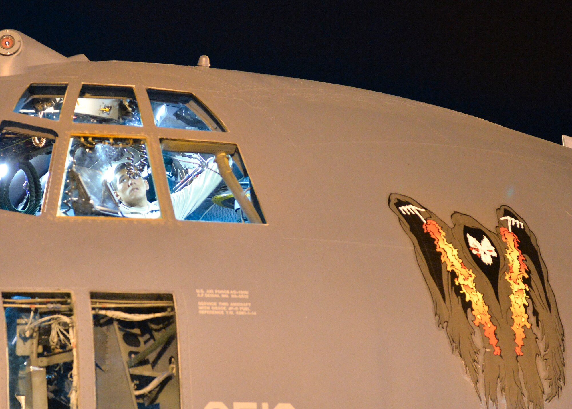 Senior Airman Craig Carillo, 1st Special Operations Aircraft Maintenance Squadron crew chief, checks the operation of the aerial refueling door on an AC-130U Spooky for any malfunctions on the flighline at Hurburt Field Fla., Oct. 23, 2013. The AC-130U, like many other aircraft in the Air Force, is equipped to receive fuel in flight. (U.S. Air Force Photo/Airman 1st Class Jeff Parkinson)