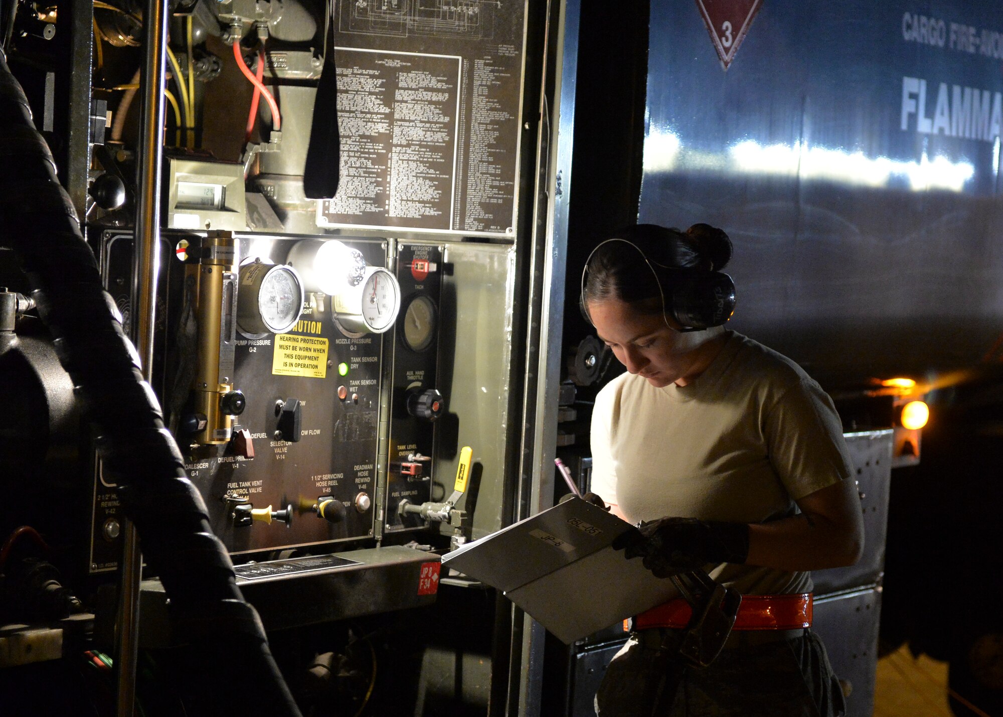 Airman 1st Class Amber Tibbetts, 1st Special Operations Logistics Readiness Squadron fuels apprentice, monitors fuel outputs during a refueling of the AC-130U Spooky on the flightline at Hurlburt Field, Fla., Oct. 23, 2013. The average output of fuel to the aircraft is 400 gallons per minute. (U.S. Air Force Photo/Airman 1st Class Jeff Parkinson)