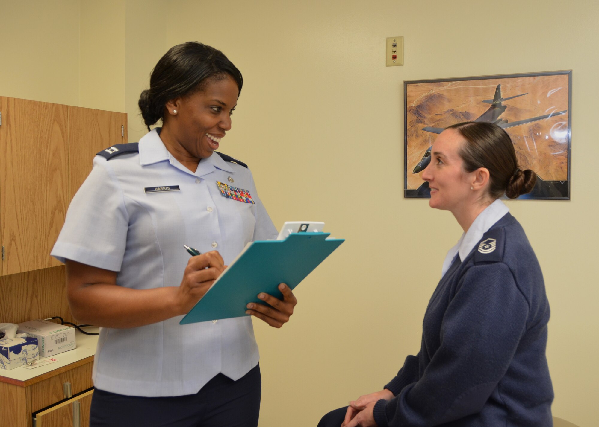 Capt. Iesiah Harris, left, interviews “patient” Master Sgt. Tanya Tennyson in the Surgery Clinic.  Harris earned a doctor of philosophy degree in health-care administration from Capella University Sept. 17 after defending her doctoral dissertation.  Both are members of the 81st Surgical Operations Squadron. (U.S. photo by Steve Pivnick)