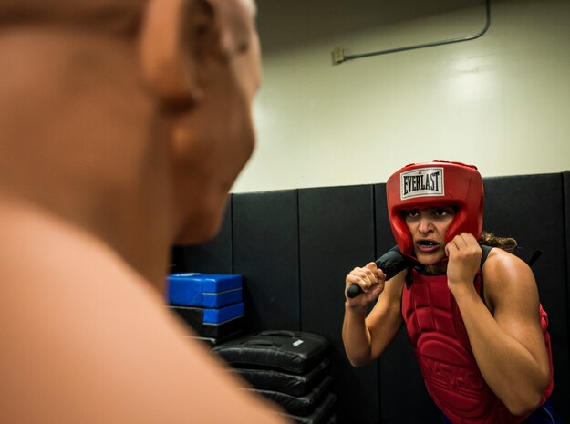 Airman 1st Class Marisa Placie, 628th Security Forces Squadron patrolman, raises her arms and baton before performing a defensive strike on a prop during a Phoenix Raven training session Oct. 10, 2013, at Joint Base Charleston, S.C. Placie and two other security forces members went through a three-week course at the JB Charleston Phoenix Raven facility to prepare them for the Phoenix Raven training course at the United States Air Force Expeditionary Center at Joint Base McGuire-Dix-Lakehurst, N.J. (U.S. Air Force photo/ Senior Airman Dennis Sloan)