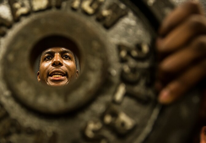 Senior Airman Martin Jackson, 628th Security Forces Squadron patrolman, holds a 25 pound weight out in front of himself while performing a wall stand during a Phoenix Raven training session Oct. 10, 2013, at Joint Base Charleston, S.C. Jackson and two other security forces members went through a three-week course at the JB Charleston Raven facility to prepare them for the Phoenix Raven training course at the United States Air Force Expeditionary Center at Joint Base McGuire-Dix-Lakehurst, N.J. (U.S. Air Force photo/ Senior Airman Dennis Sloan)