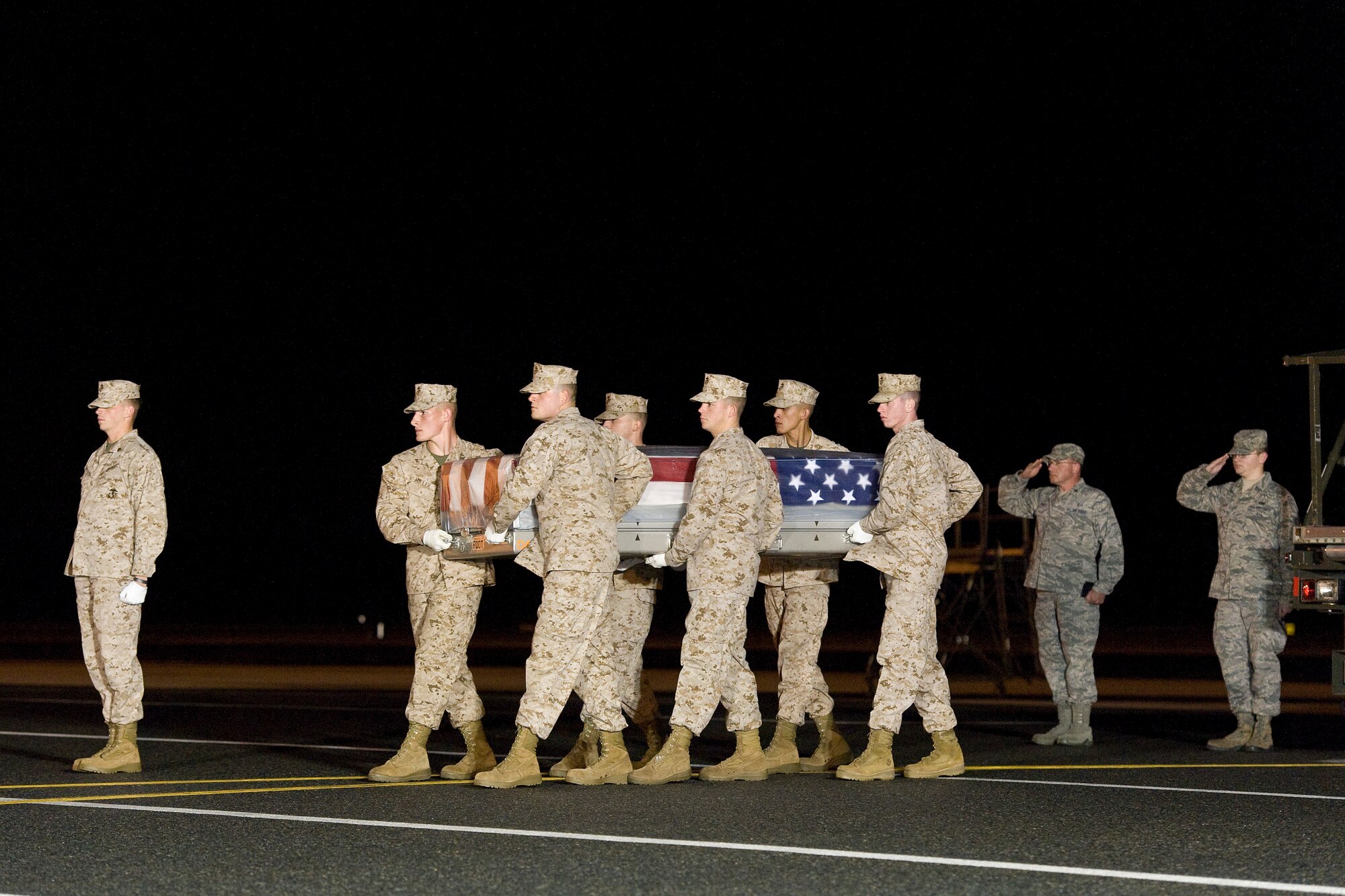 A U.S. Marine Corps carry team transfers the remains of Marine Lance Cpl. Christopher O. Grant, of Richwood, La., at Dover Air Force Base, Del., Oct. 23, 2013. Grant was assigned to 1st Battalion, 9th Marines, 2nd Marine Division, II Marine Expeditionary Force, Camp Lejeune, N.C. (U.S. Air Force photo/Roland Balik)