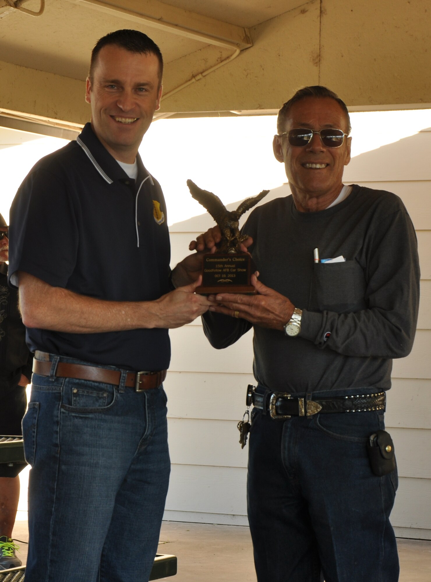 GOODFELLOW AIR FORCE BASE, Texas – Col. Thomas Schmidt, 17th Training Wing Vice Commander, awards Les Gray, car show competitor, with the Commander’s Choice Award at the 15th Annual Goodfellow Air Force Base Recreation Camp Car, Boat and Motorcycle Show at the Goodfellow Rec Camp Oct. 19. Gray’s award winning car was a 1957 Ford Fairlane.  (U.S. Air Force photo/ Airman 1st Class Joshua Edwards)