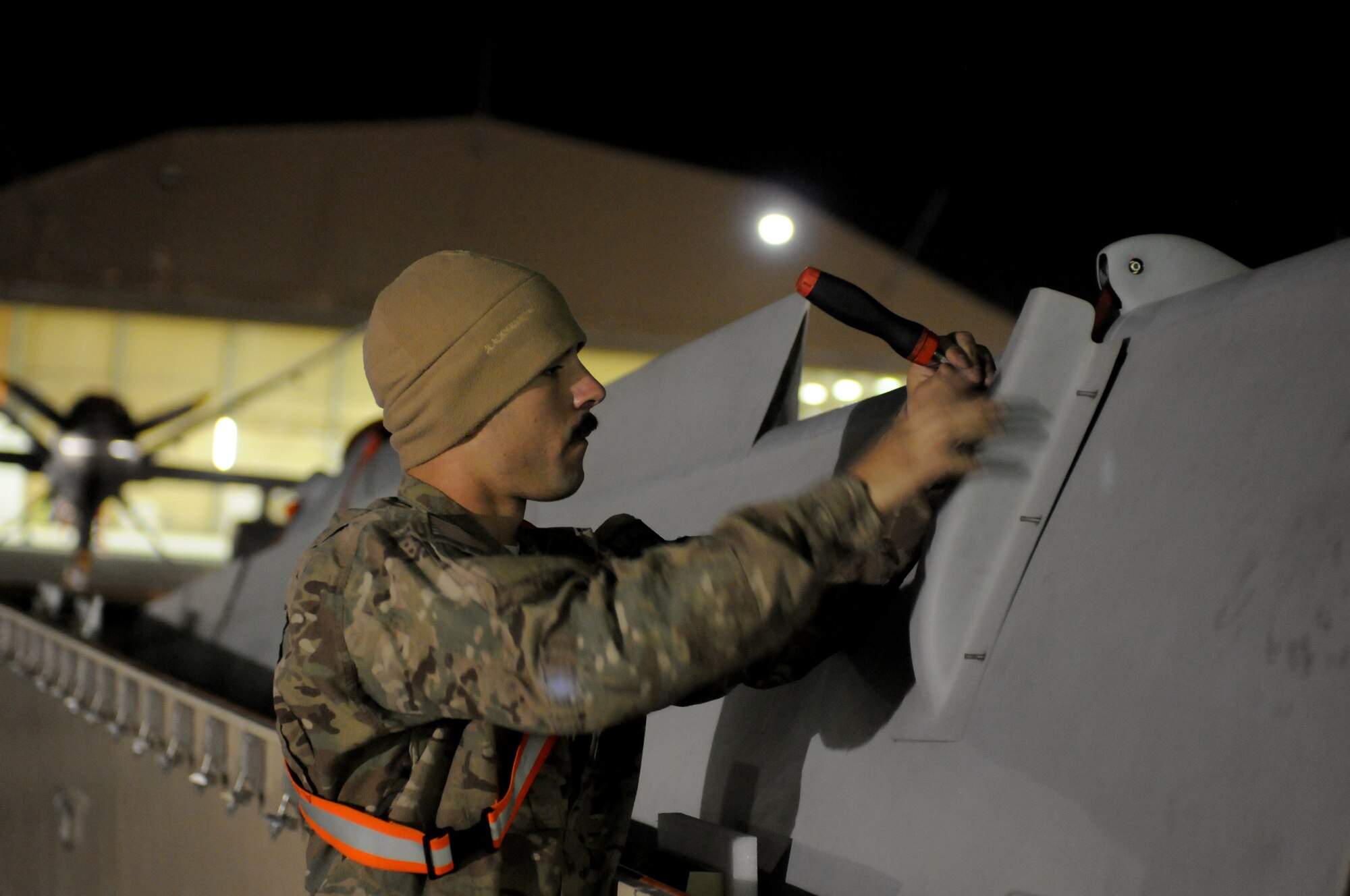 Airman 1st Class Alex Slobozien, 451st Expeditionary Maintenance Squadron crewchief, puts together parts of a wing for an MQ-9 Reaper Oct. 18, 2013, at Kandahar Airfield, Afghanistan. MQ-9 Reapers arrived here in cargo containers and require the crewchiefs to assemble them on station. (U.S. Air Force photo by Senior Airman Jack Sanders)