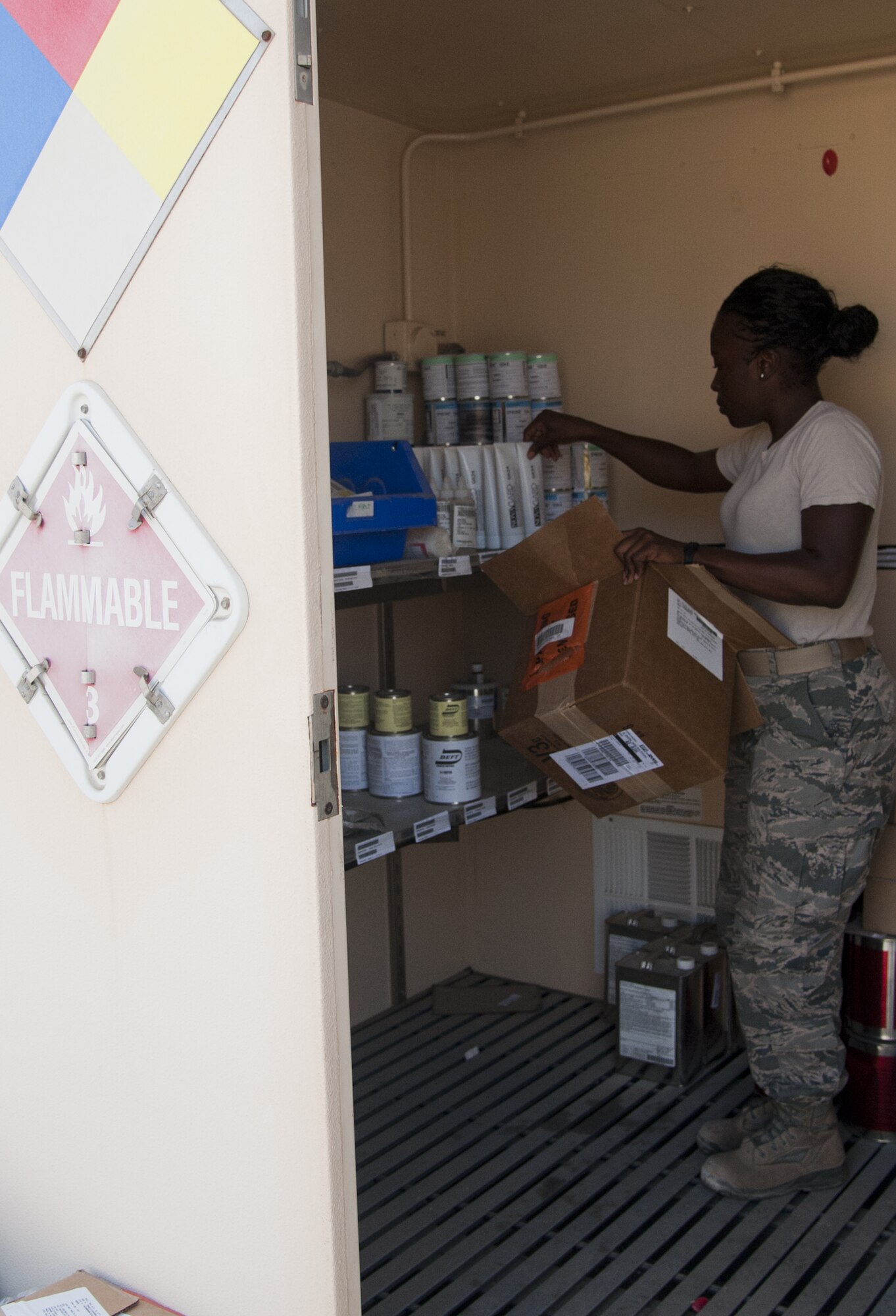 U.S. Air Force Tech Sgt. Karrell Thompson, 380th Expeditionary Logistics Readiness Squadron Hazardous Material Pharmacy NCO in charge, stocks a hazardous material storage locker at an undisclosed location in Southwest Asia Oct. 8, 2013. Thompson stores everything from pressurized liquid oxygen to highly flammable liquids. Thompson calls New York City, N.Y., home and is deployed from Joint Base McGuire-Dix-Lakehurst, N.J. (U.S. Air Force photo by Staff Sgt. Jacob Morgan)