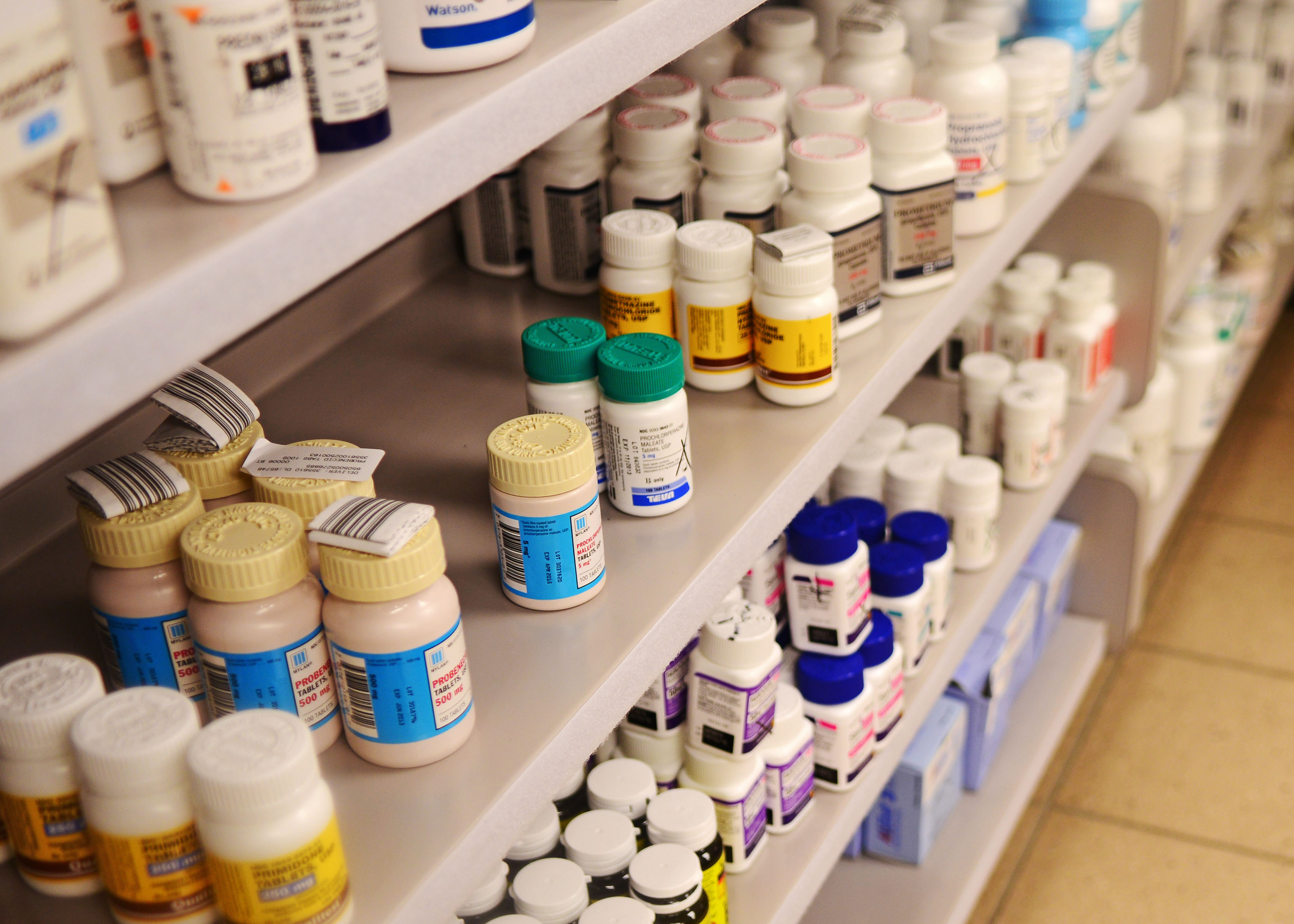 Medication sitting on a shelf at a pharmacy.