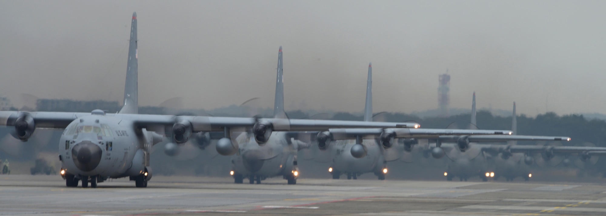 C-130 Hercules’taxi down the runway at Yokota Air Base, Japan, Oct. 22, 2013. The C-130s from the 36th Airlift Squadron participated in a large formation mission, as Yokota tested its ability to quickly generate aircraft. (U.S. Air Force photo by Airman 1st Class David Danford/Released)
