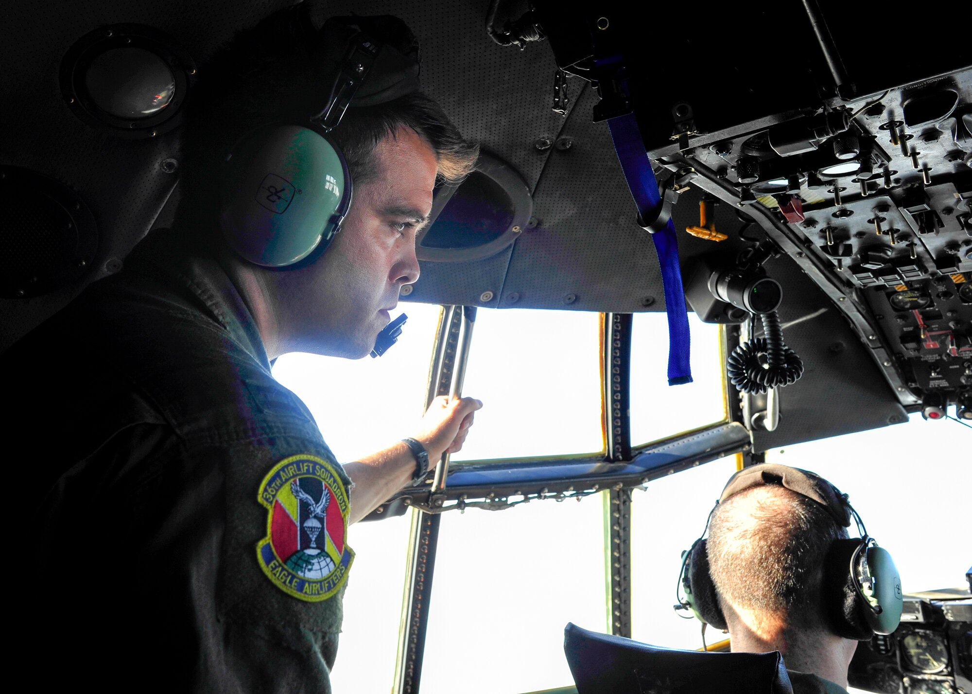 Capt. Matthew Andrews, 36th Airlift Squadron mission commander, stays vigilant during a flight mission over the Kanto Plains, Japan, on Oct. 22, 2013.  The C-130s flew towards the Aomori region as part of a large formation mission, testing Yokota’s capability to launch aircraft and assist anywhere in the Western Pacific region.  (U.S. Air Force photo by Airman 1st Class Soo C. Kim/released)