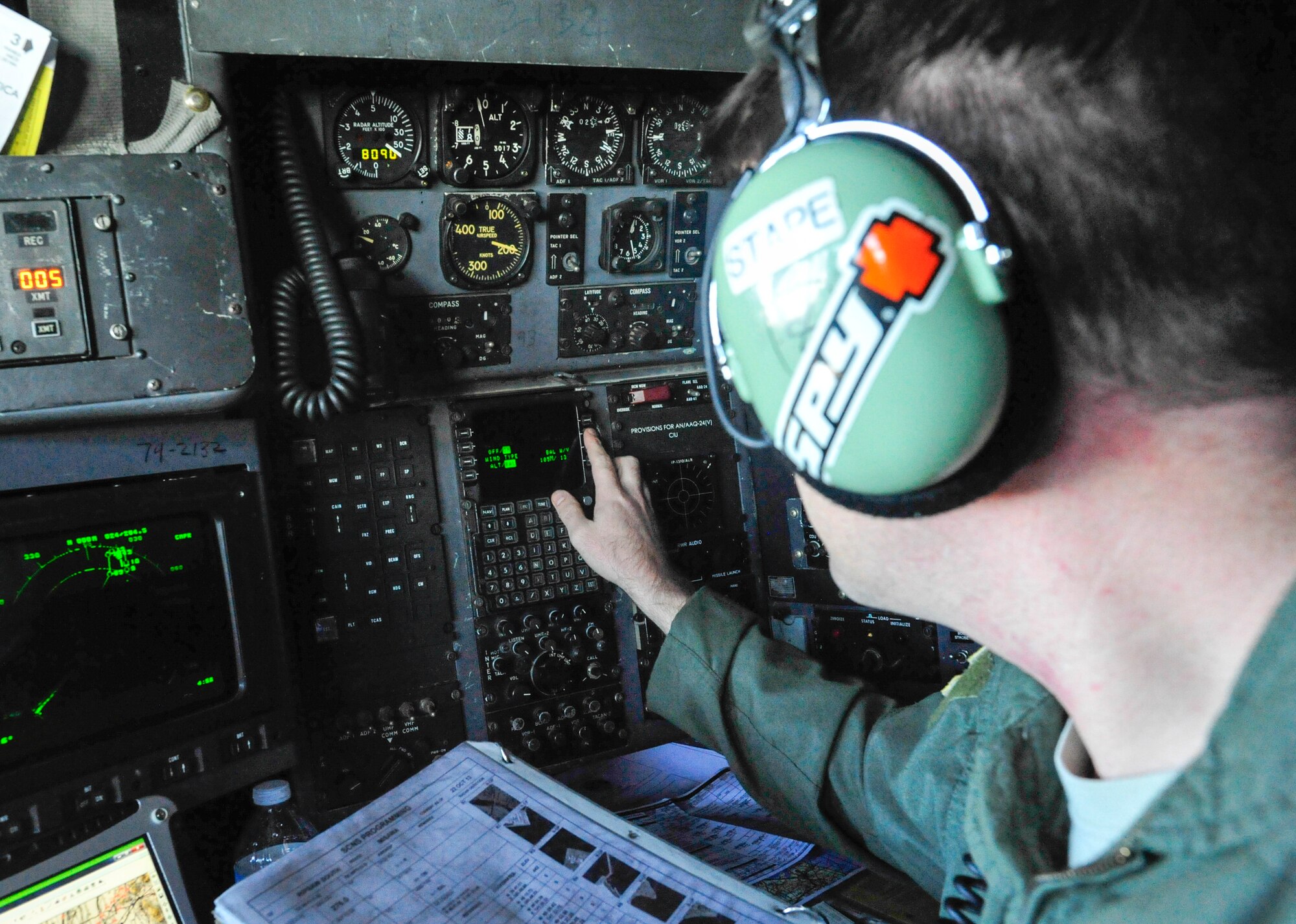 Capt. Christopher Stapenhorst, 36th Airlift Squadron navigator, performs pre-flight check during a large formation mission at Yokota Air Base, Japan, Oct. 22, 2013.  Yokota launched total of ten C-130s to test its capability to assist anywhere in the Western Pacific theater.  (U.S. Air Force photo by Airman 1st Class Soo C. Kim/released)