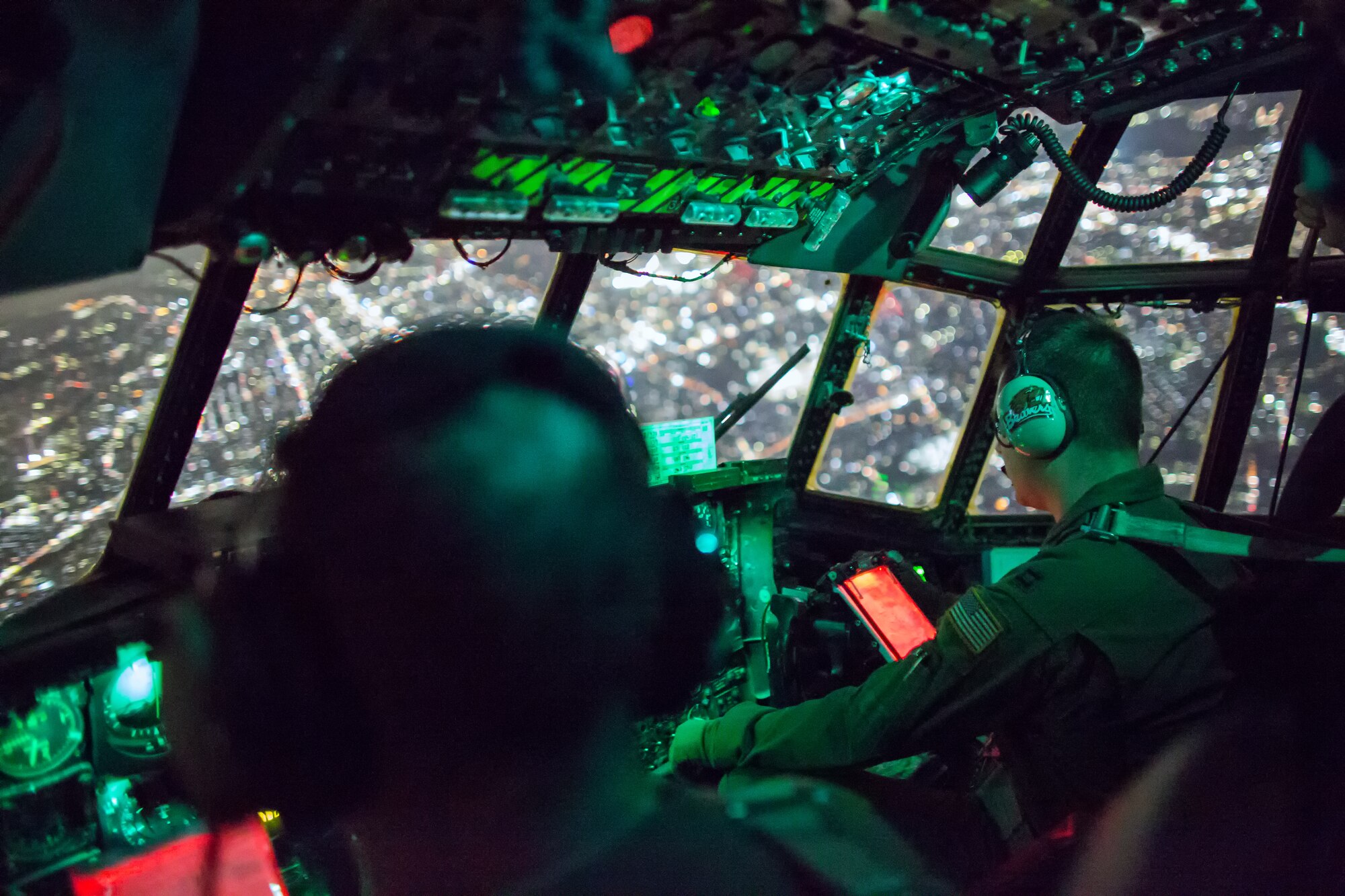 (Left to right) Col. Mark August, 374th Airlift Wing commander, Tech. Sgt. Ivory Wilds, 36th Airlift Squadron flight engineer, and Capt. Chance Hansen, 36th Airlift Squadron pilot, approach Yokota Air Base, Japan, after a surge flight, Oct. 22, 2013.  The crew flew as part of a large formation flight that showcased Yokota’s mission as the primary airlift hub for the Western Pacific.  (U.S. Air Force photo by Osakabe Yasuo/Released) 