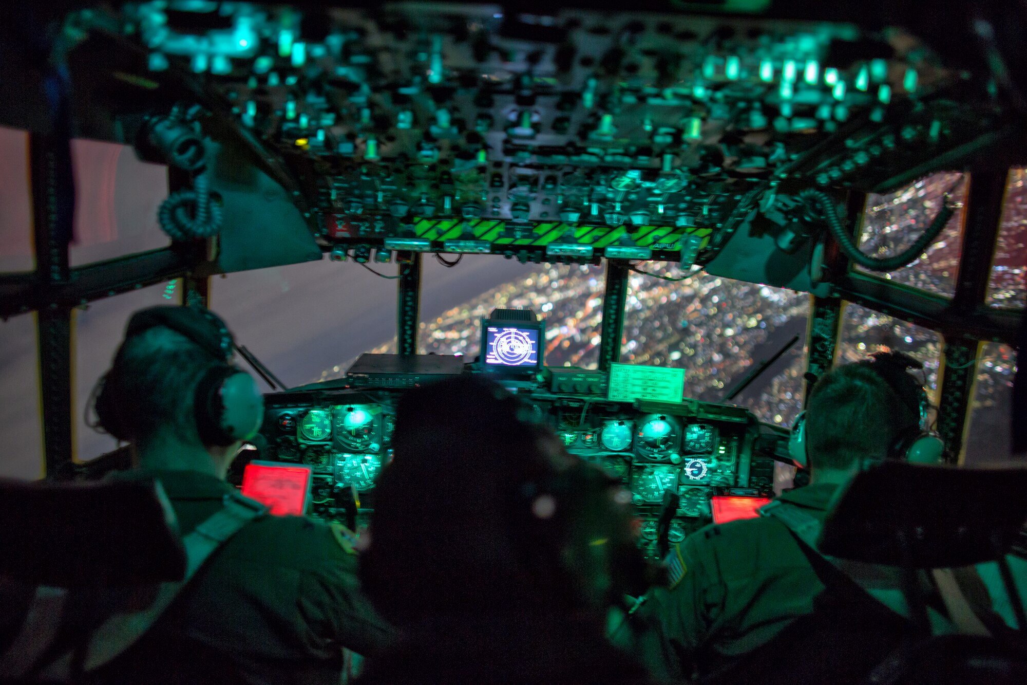 (Left to right) Col. Mark August, 374th Airlift Wing commander, Tech. Sgt. Ivory Wilds, 36th Airlift Squadron flight engineer, and Capt. Chance Hansen, 36th Airlift Squadron pilot, approach Yokota Air Base, Japan, after a surge flight, Oct. 22, 2013.  The crew flew as part of a large formation flight that showcased Yokota’s mission as the primary airlift hub for the Western Pacific.  (U.S. Air Force photo by Osakabe Yasuo/Released) 
