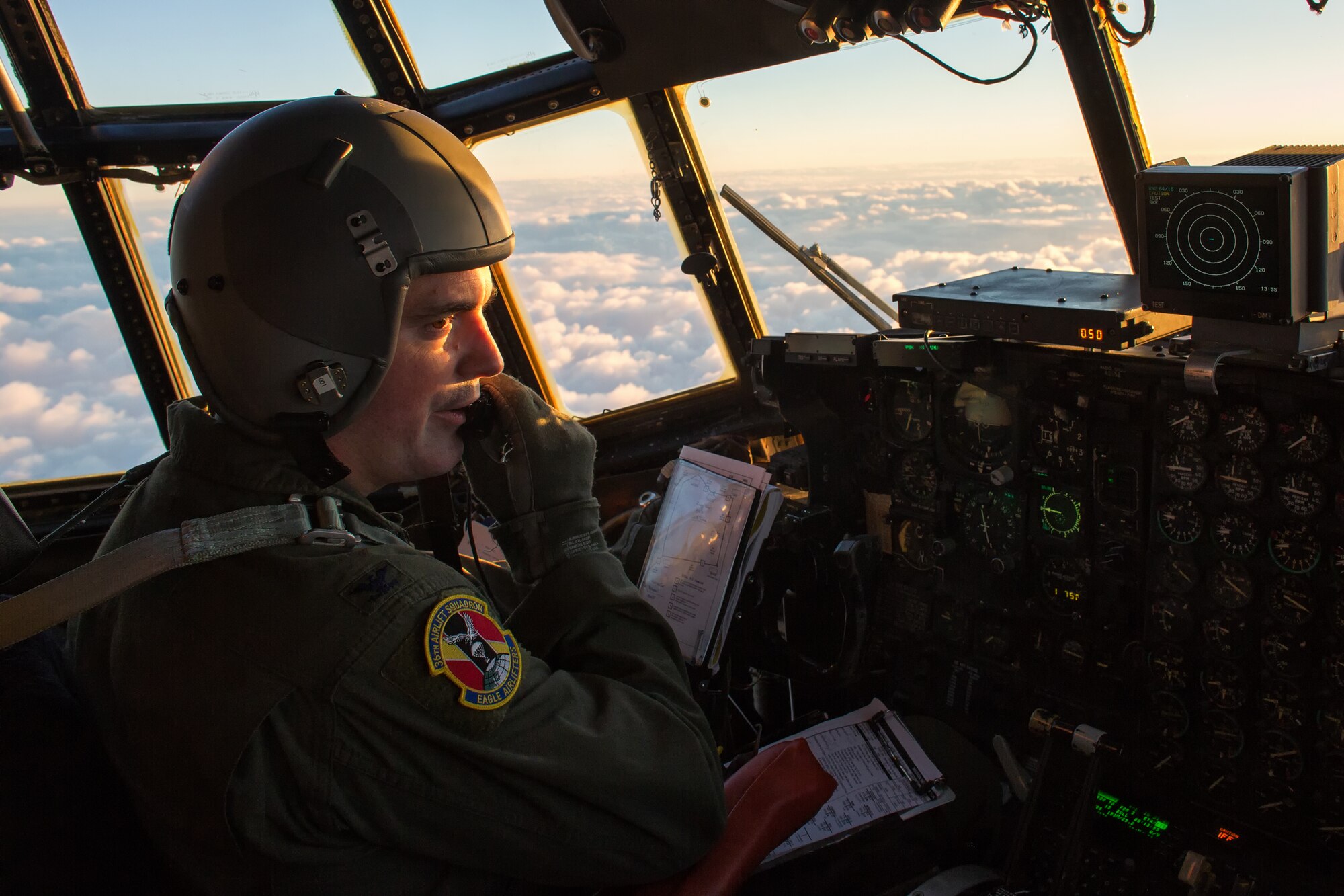 Col. Mark August, 374th Airlift Wing commander, communicate with aircrews during a large formation flight above mainland Japan, Oct. 22, 2013. The C-130 aircrews demonstrated their airlift capabilities during a surge flight.  (U.S. Air Force photo by Osakabe Yasuo/Released) 
