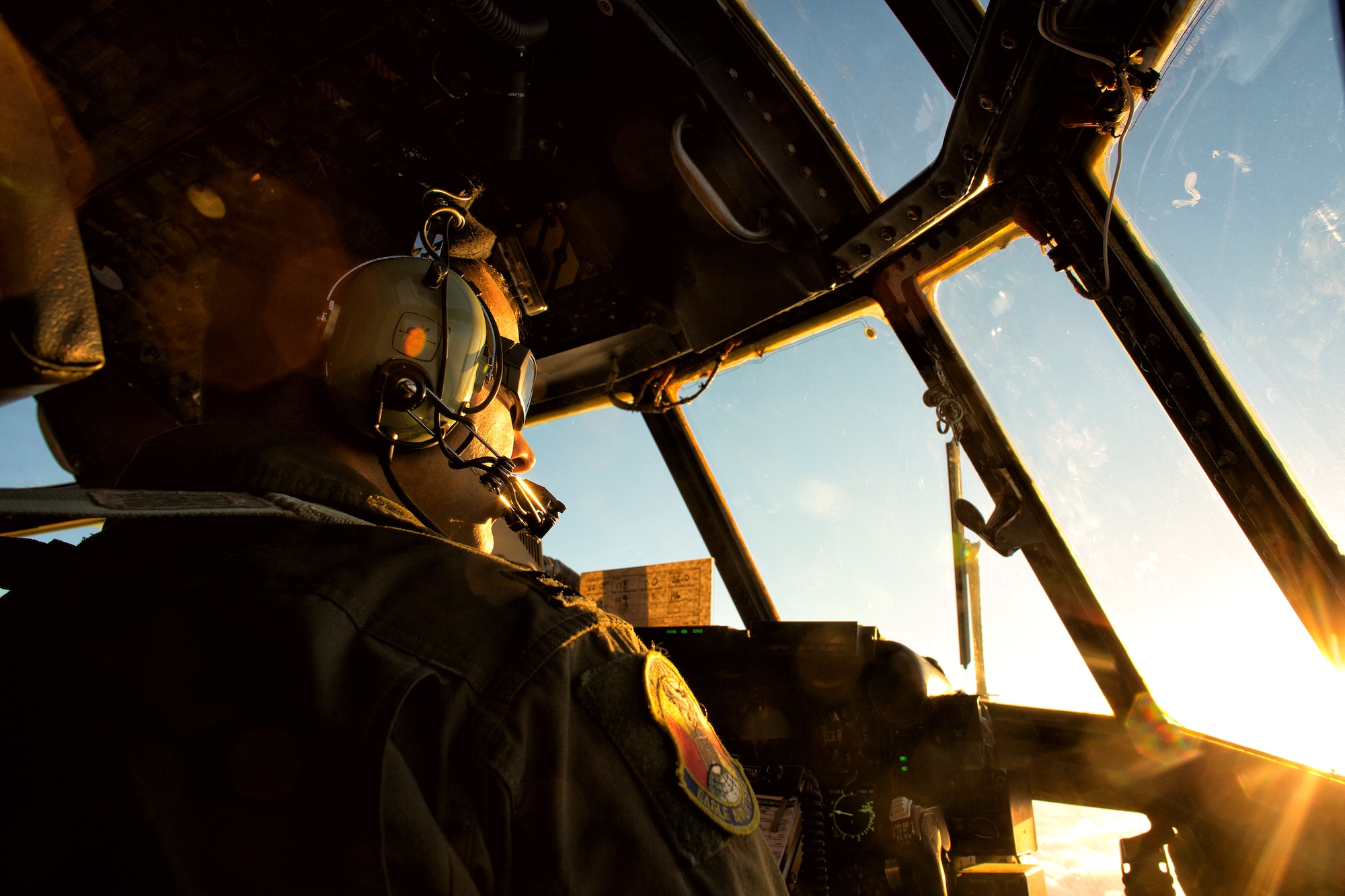Capt. Chance Hansen, 36th Airlift Squadron pilot, performs visually identification of another C-130 Hercules above mainland Japan, Oct. 22, 2013. The C-130 aircrews demonstrated their airlift capabilities during a large formation flight.  (U.S. Air Force photo by Osakabe Yasuo/Released)
 
