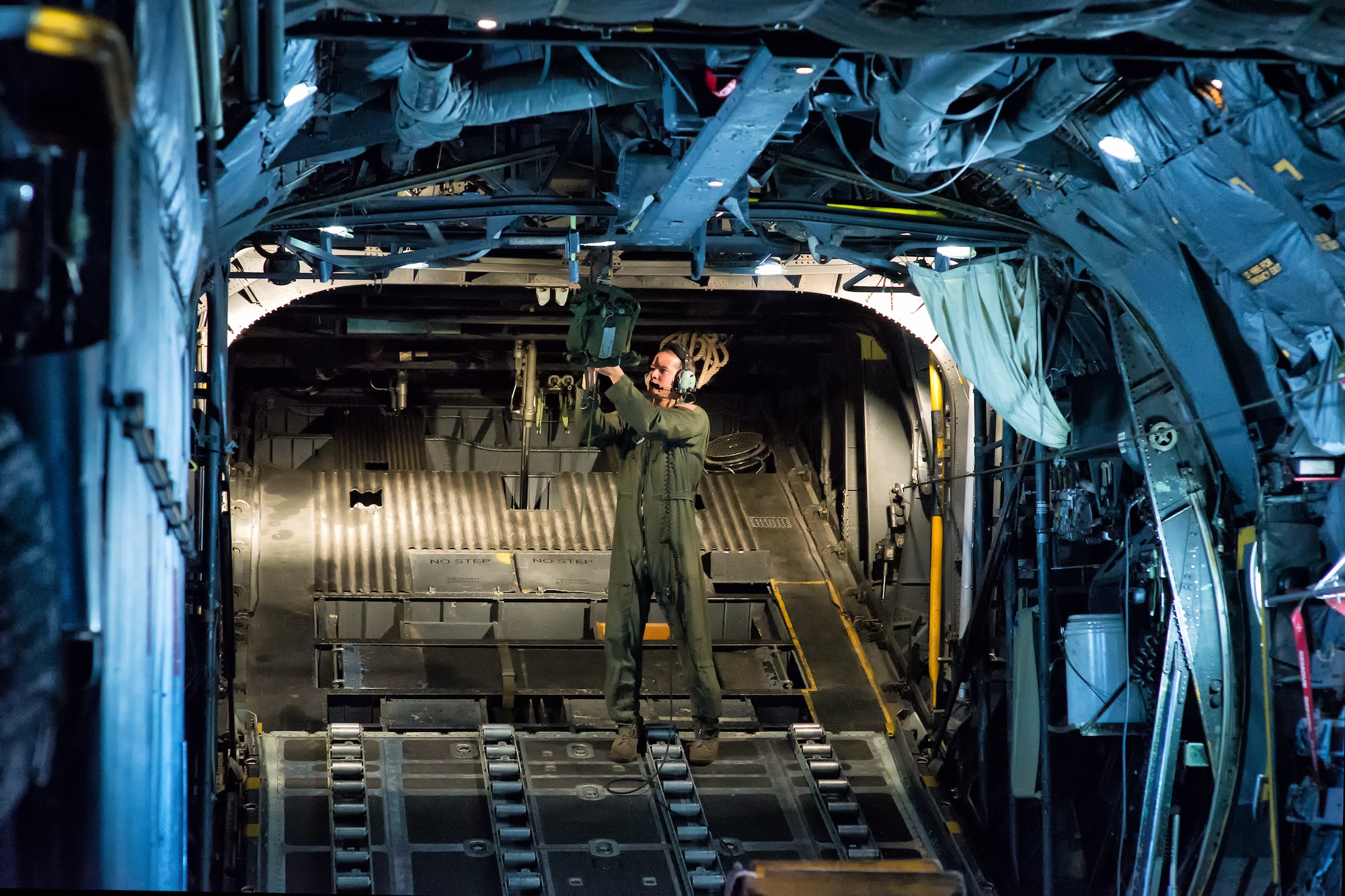 Staff Sgt. Nicolas Alarcon, 36th Airlift Squadron loadmaster, sets up a light payload on a C-130 Hercules at Yokota Air Base, Japan, Oct. 22, 2013. Ten C-130 aircrews demonstrated their airlift capabilities during a large formation flight that showcased Yokota’s mission as the primary airlift hub in the Western Pacific. (U.S. Air Force photo by Osakabe Yasuo/Released)
