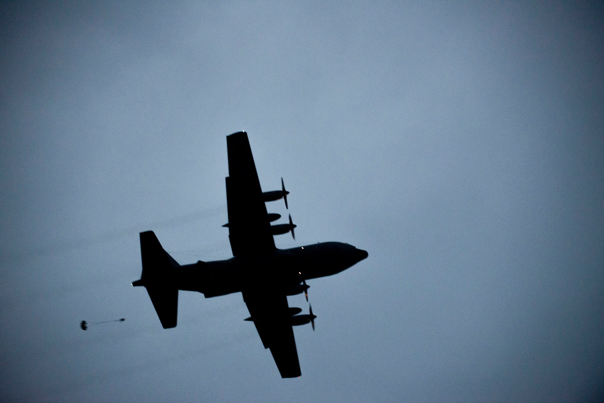A C-130 Hercules drops a sand bag during a training mission at a bombing range near Misawa Air Base, Japan, Oct. 22, 2013. The training mission was a chance to practice large flight formations and showcase Yokota’s mission as the primary airlift hub for the Western Pacific.  (U.S. Air Force photo by Senior Airman Michael Washburn/Released)