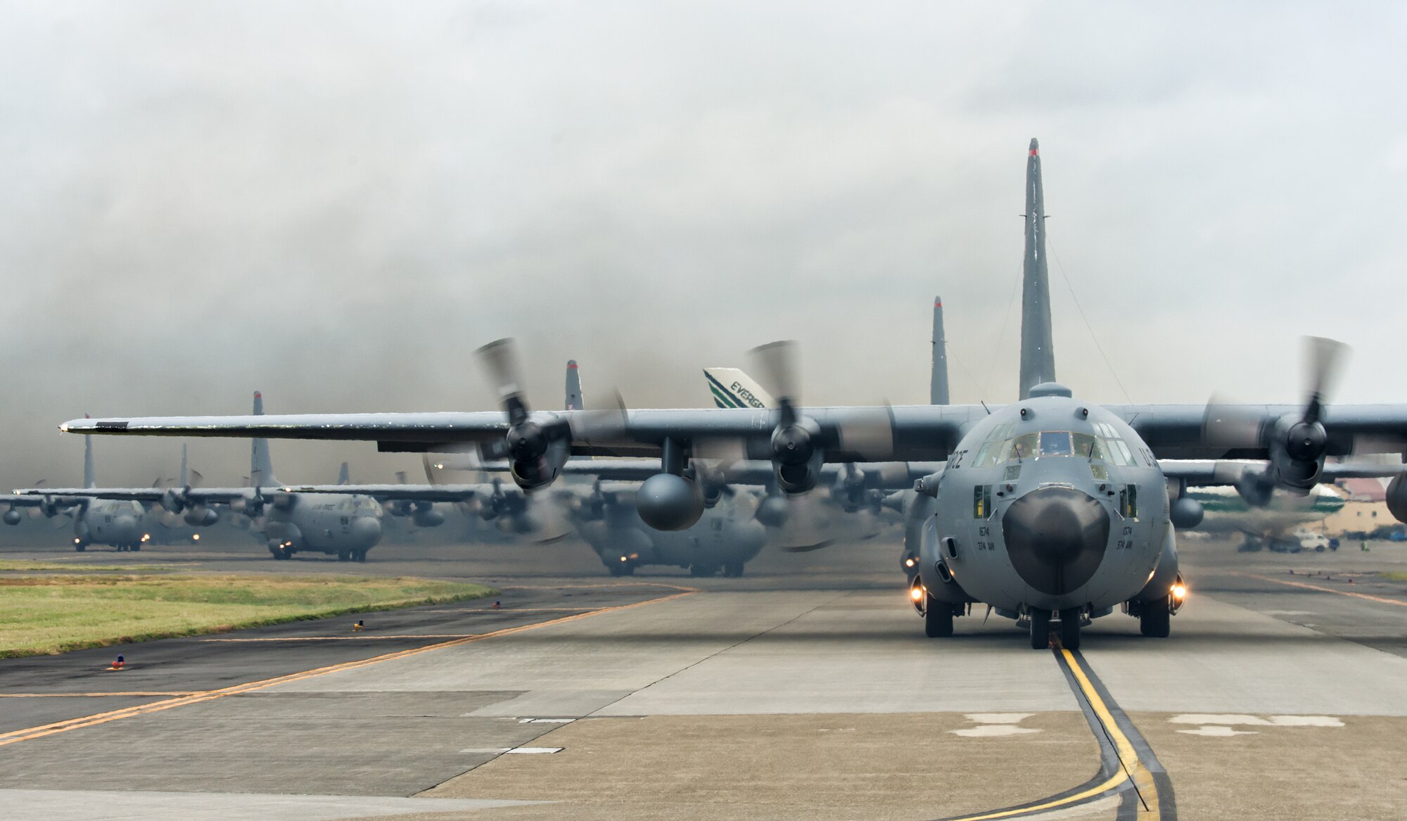 Ten C-130 Hercules from the 36th Airlift Squadron taxi out for a training mission during a ten-ship sortie at Yokota Air Base, Japan, Oct. 22, 2013. The training tested Yokota's ability to perform large-force employment and tactics. (U.S. Air Force photo by Osakabe Yasuo/Released)