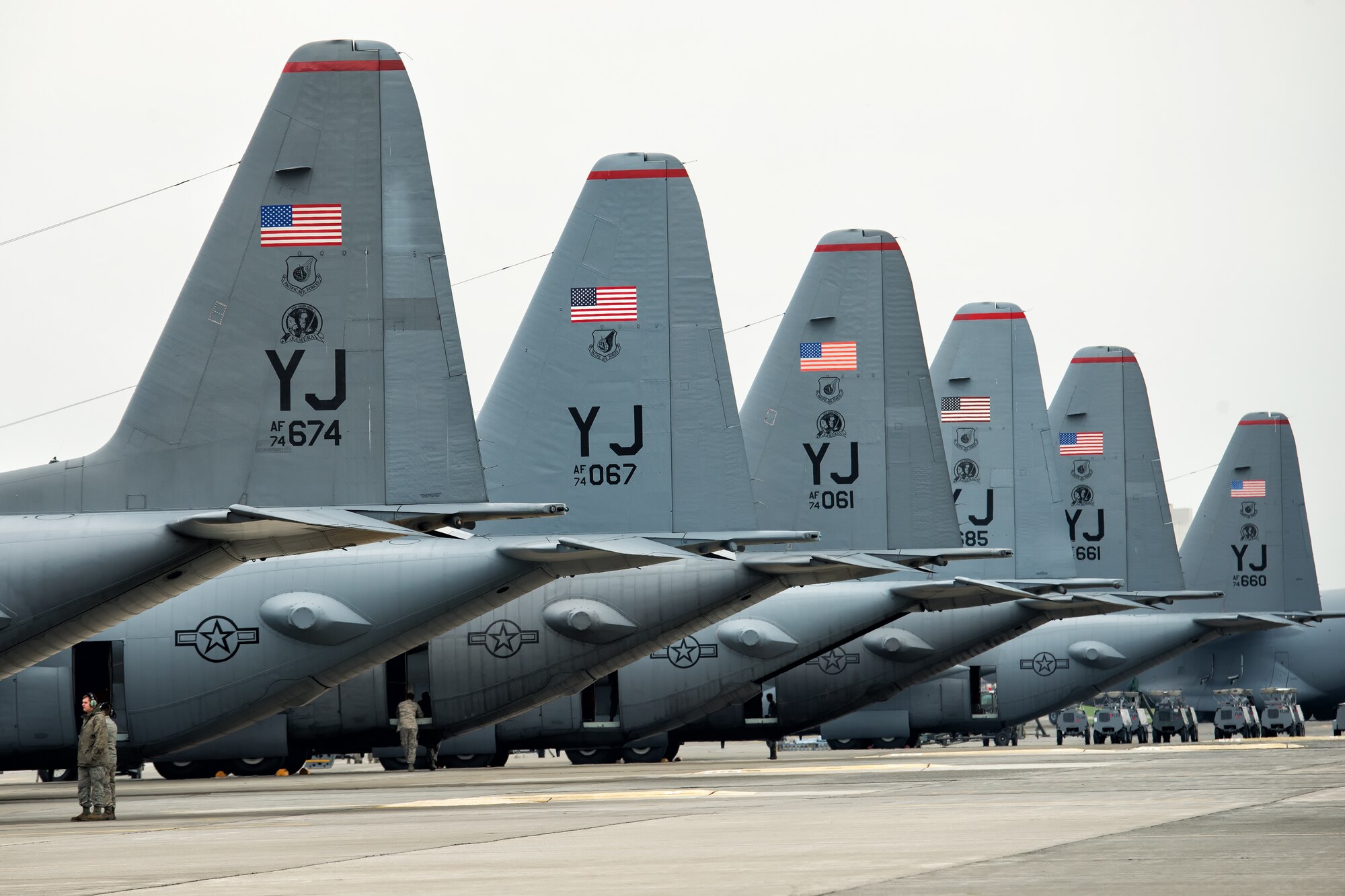 C-130 Hercules' from the 36th Airlift Squadron sit on the flight line at Yokota Air Base, Japan, Oct. 22, 2013. Ten C-130 Hercules from the 36th Airlift Squadron participated in a large formation training flight that tested Yokota's ability to perform large-force employment and tactics. (U.S. Air Force photo by Osakabe Yasuo/Released)