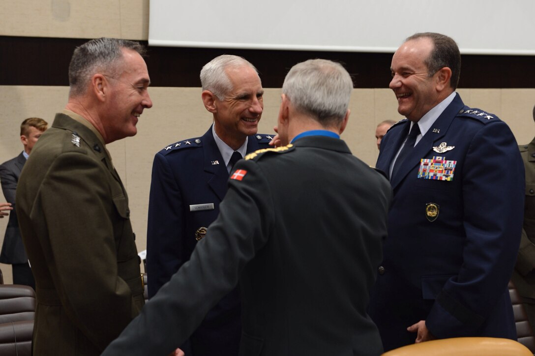 U.S. Air Force Gen. Philip M. Breedlove, right, the commander of U.S. European Command and the associated role of NATO supreme allied commander for Europe, speaks with U.S. Air Force Lt. Gen. Mark O. Schissler, second from left, deputy chairman of NATO's military committee, U.S. Marine Corps Gen. Joseph F. Dunford Jr., far left, commander of the International Security Assistance Force, and a foreign military member before the North Atlantic Council meeting with NATO and partner nations that contribute to the international force at NATO headquarters in Brussels, Oct. 23, 2013. 