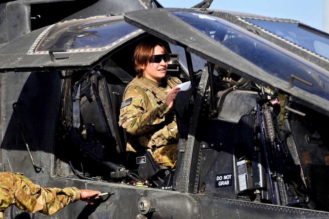 U.S. Army Chief Warrant Officer 2 Amanda Combs prepares her AH-64 Apache helicopter for a security and reconnaissance mission over Logar and Wardak provinces from Forward Operating Base Shank in Afghanistan's Logar province, Oct. 22, 2013. Combs, a pilot, is assigned to 2nd Battalion Assault, 10th Combat Aviation Brigade.