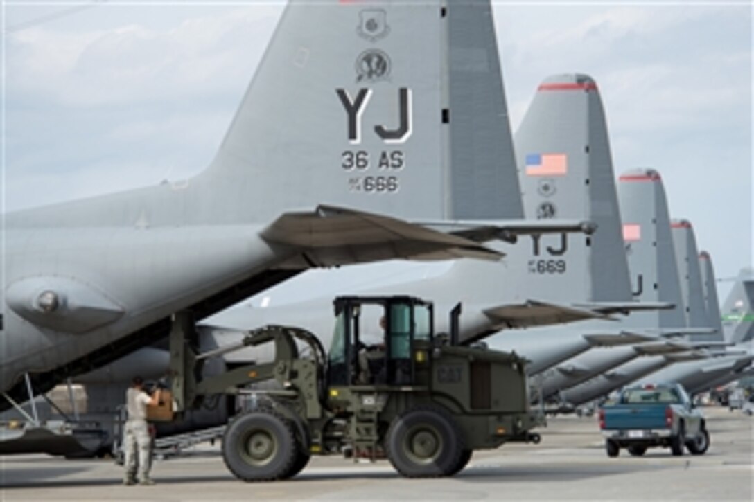 U.S. Air Force airmen from the 374th Logistics Readiness Squadron combat mobility flight load a low-cost, low-altitude cargo bundle into a C-130 Hercules at Yokota Air Base, Japan, on Oct. 8, 2013.  Airmen from the 374th maintain and prepare aerial cargo delivery systems and equipment for use during training exercises and real-world deployments. 